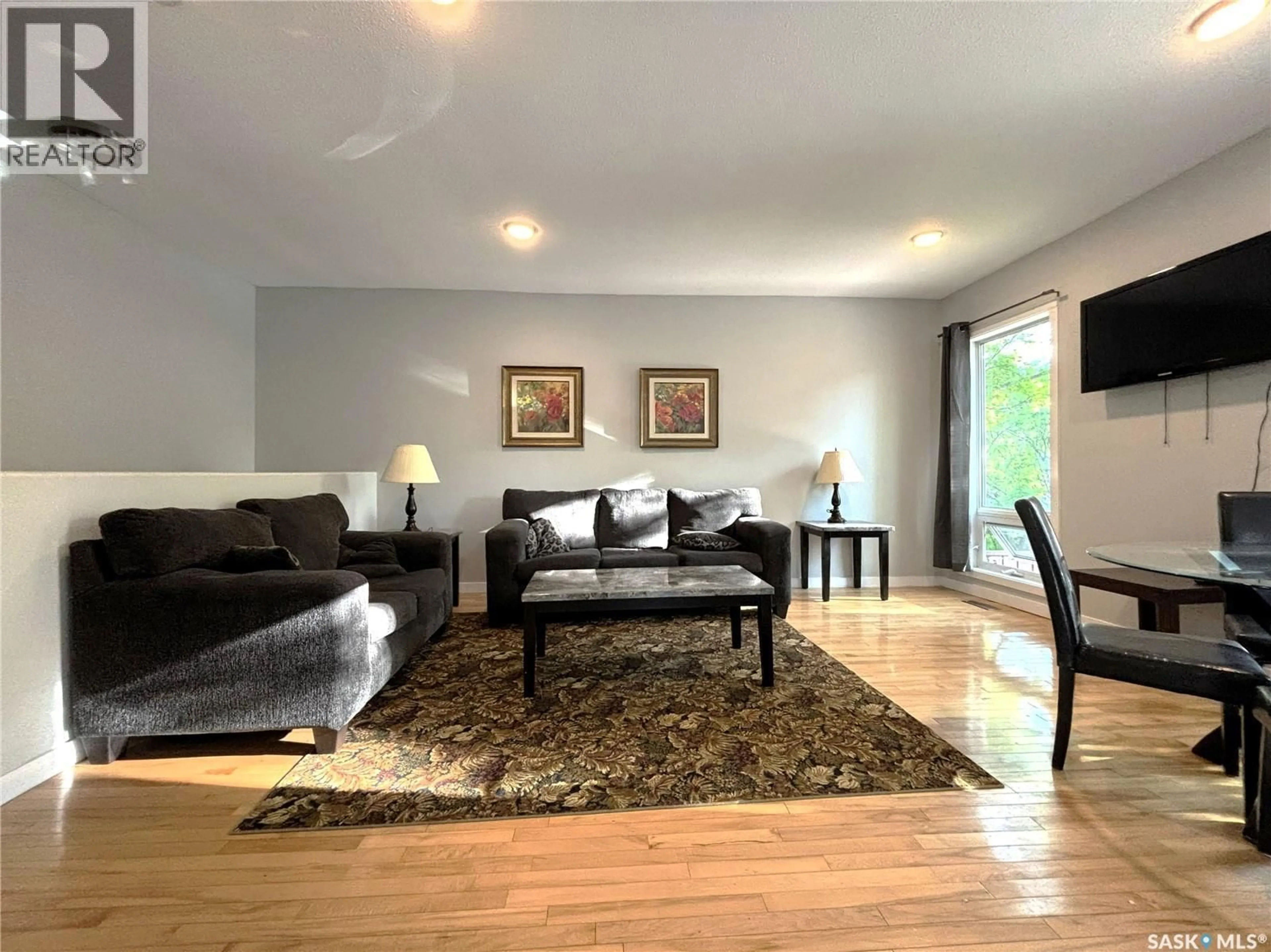 Living room with furniture, wood/laminate floor for 819 5TH AVENUE, Saskatoon Saskatchewan S7K2R7