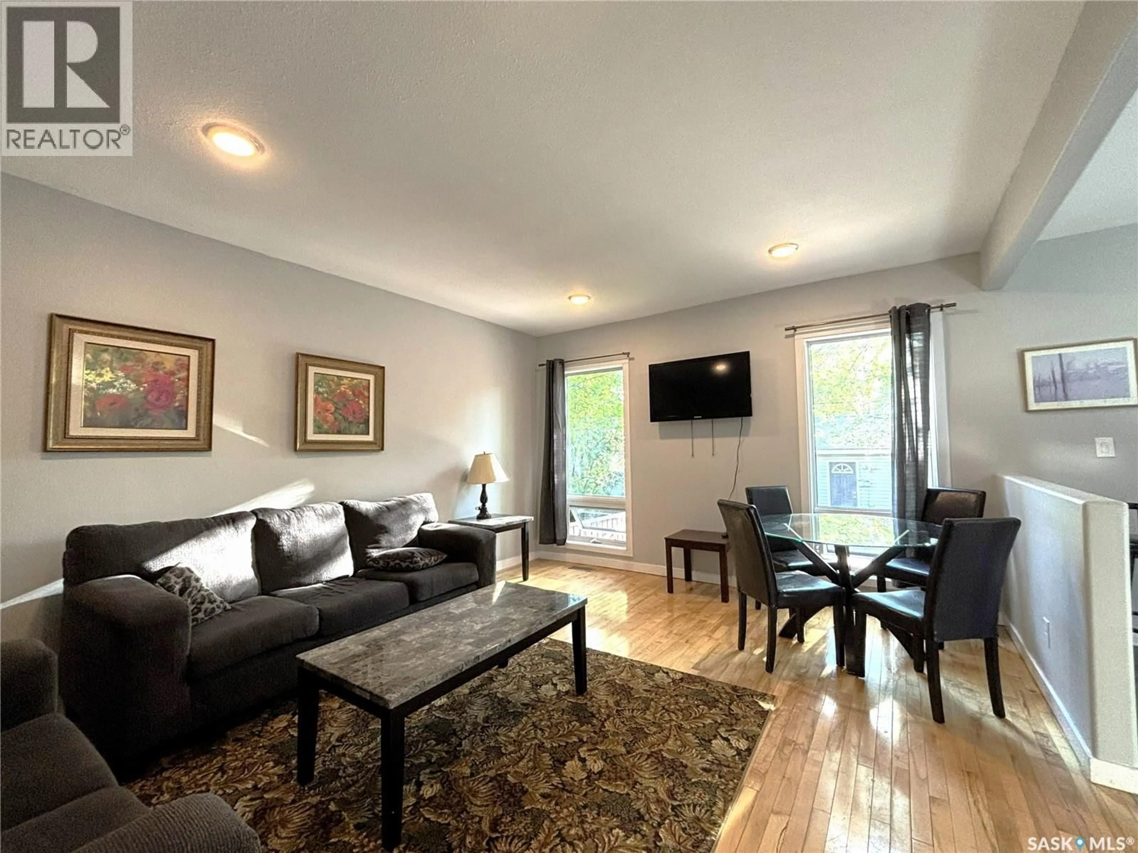 Living room with furniture, wood/laminate floor for 819 5TH AVENUE, Saskatoon Saskatchewan S7K2R7