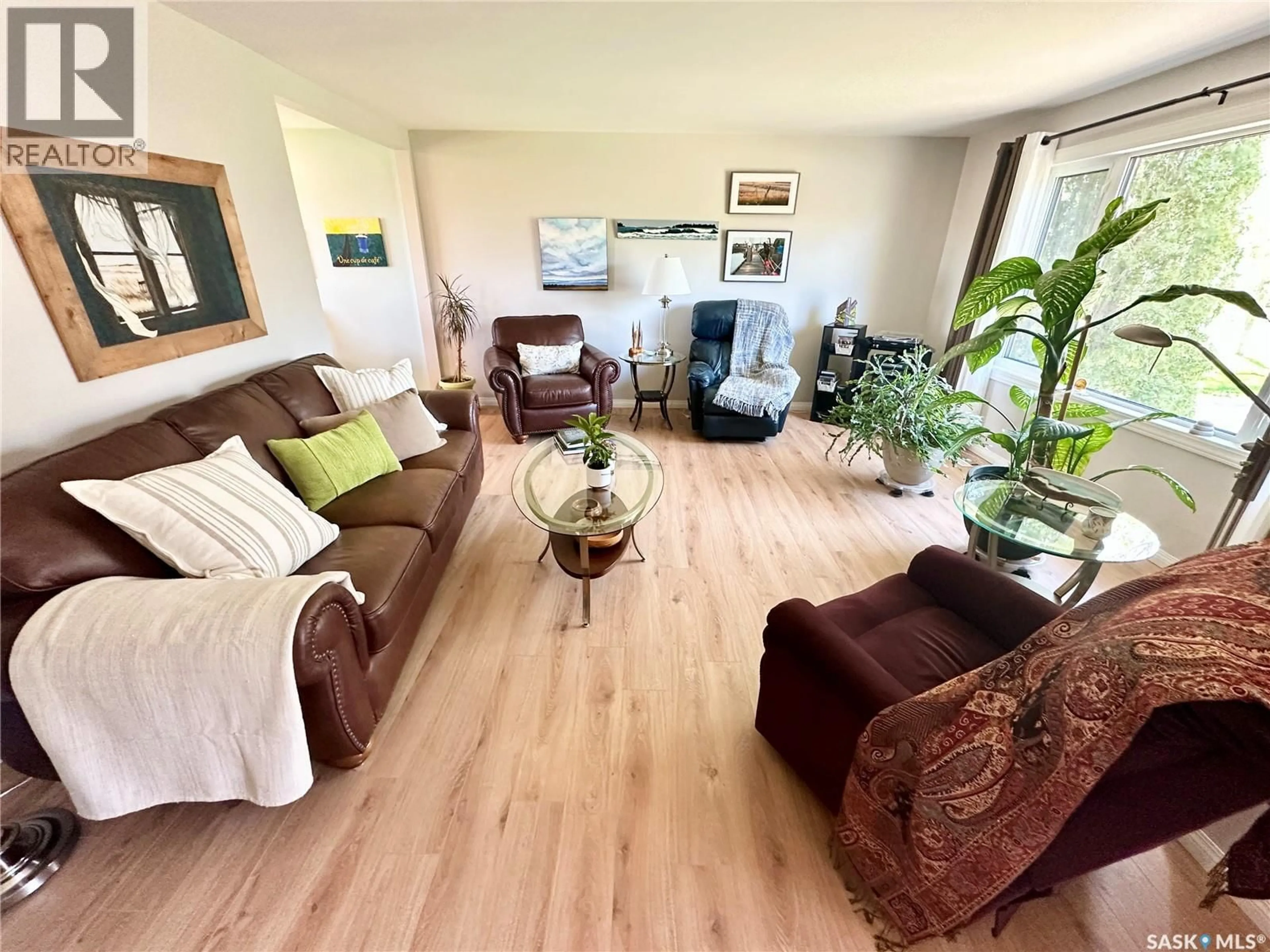 Living room with furniture, wood/laminate floor for 309 RUSSELL STREET, Stoughton Saskatchewan S0G4T0