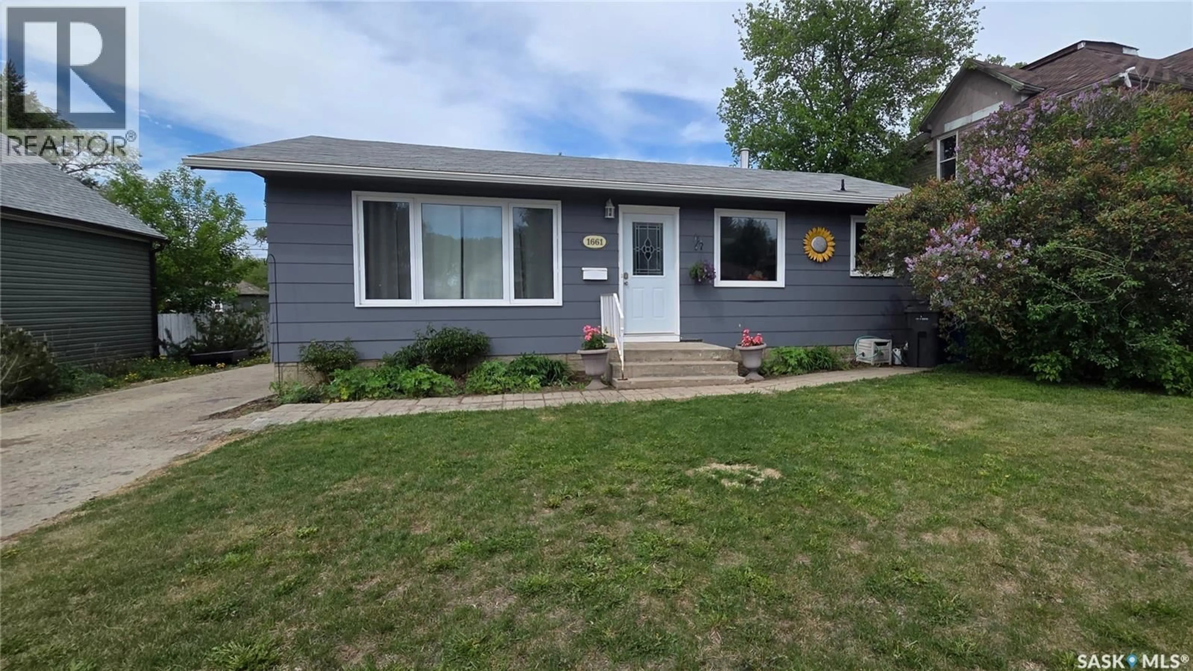 Home with vinyl exterior material, street for 1661 103RD STREET, North Battleford Saskatchewan S9A1L6
