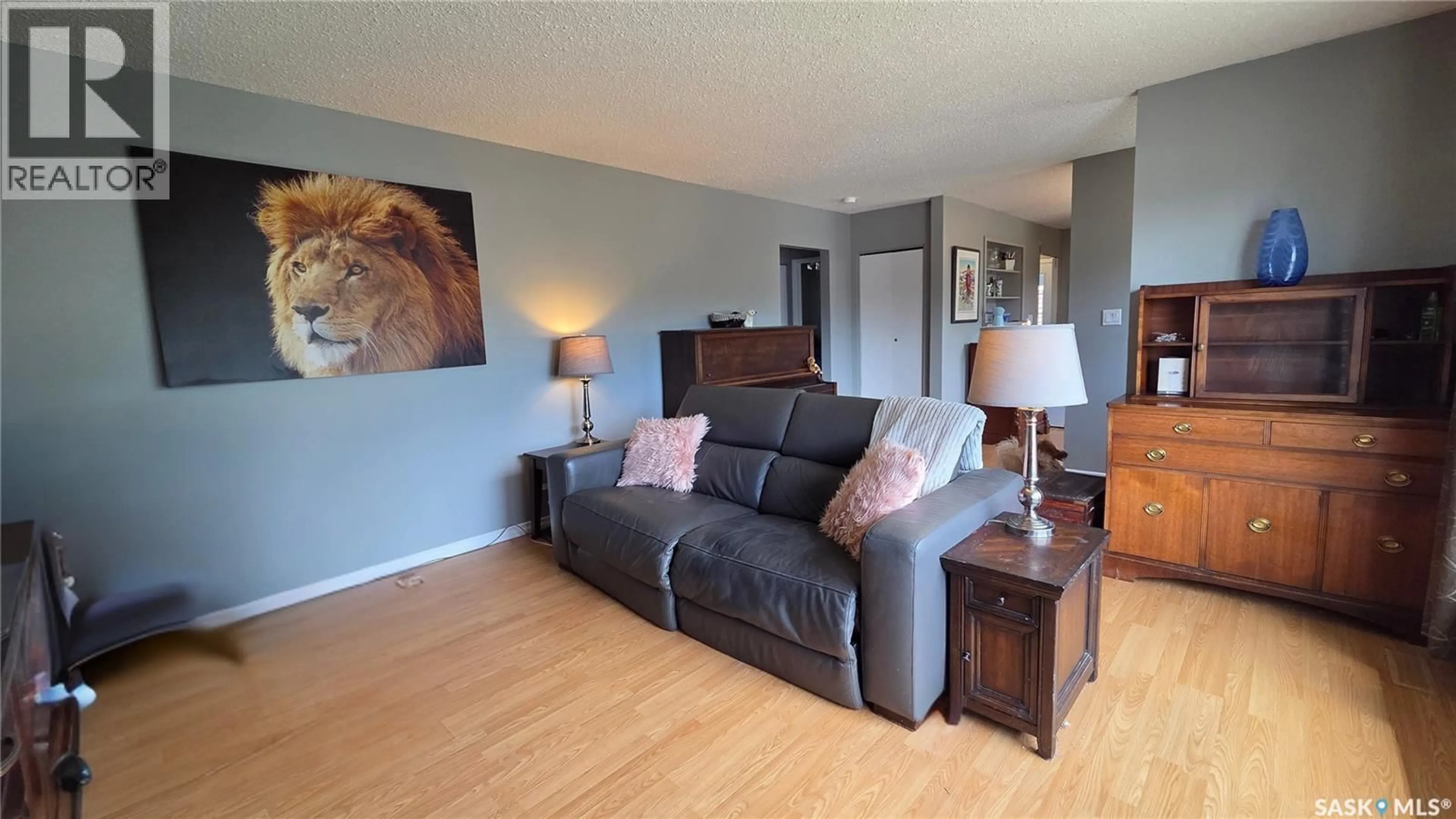 Living room with furniture, wood/laminate floor for 1661 103RD STREET, North Battleford Saskatchewan S9A1L6