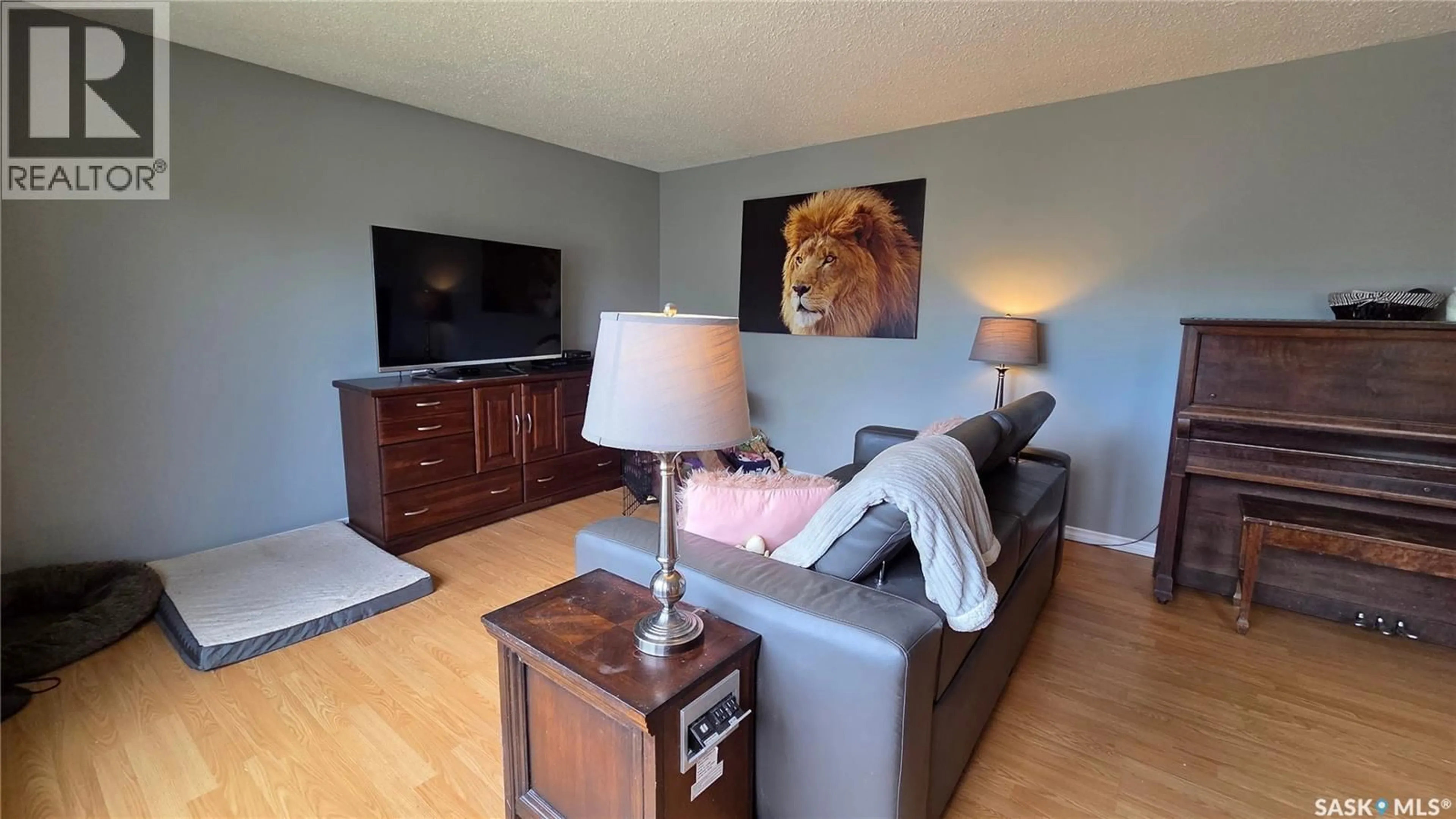 Living room with furniture, wood/laminate floor for 1661 103RD STREET, North Battleford Saskatchewan S9A1L6