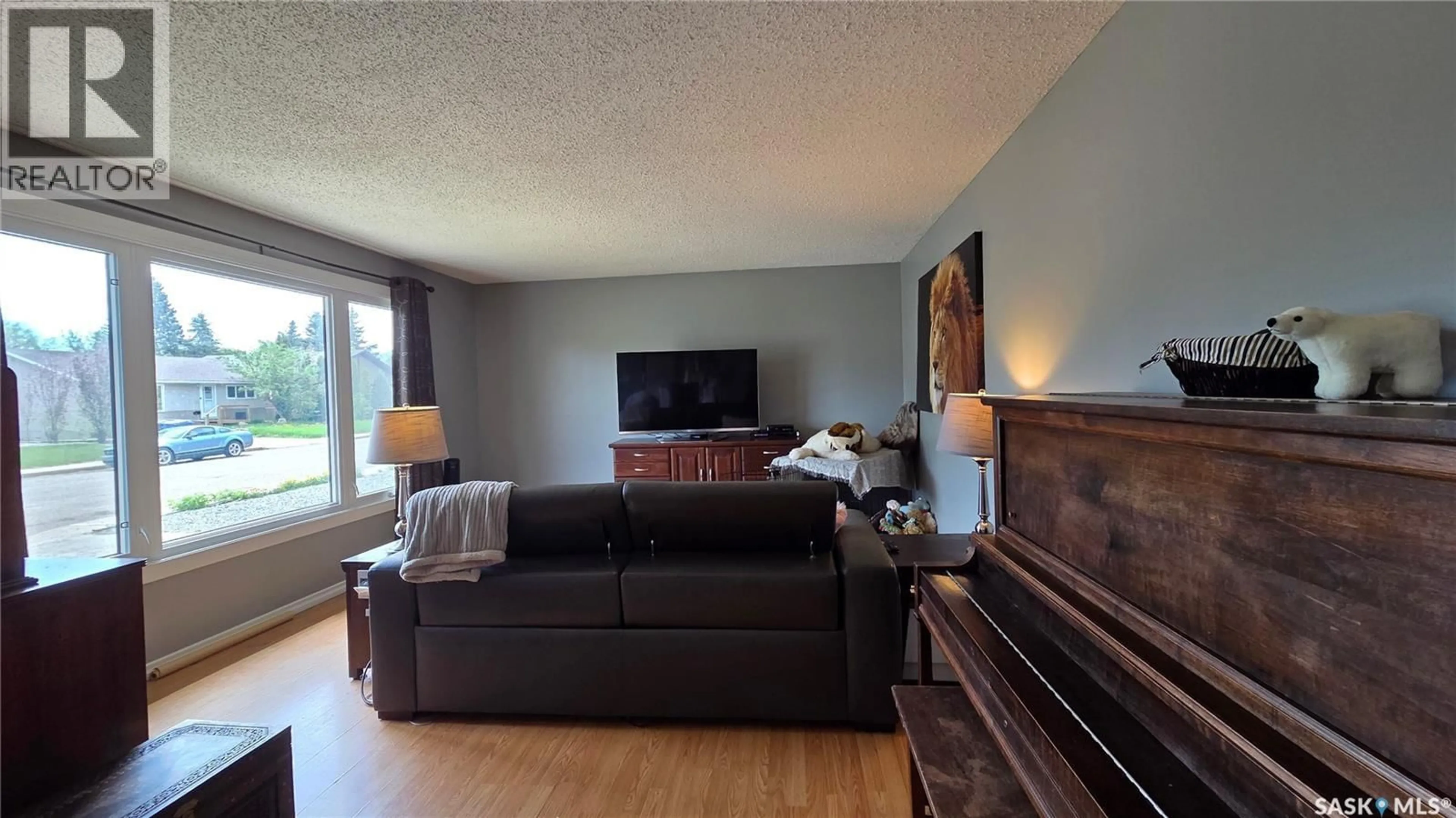 Living room with furniture, wood/laminate floor for 1661 103RD STREET, North Battleford Saskatchewan S9A1L6