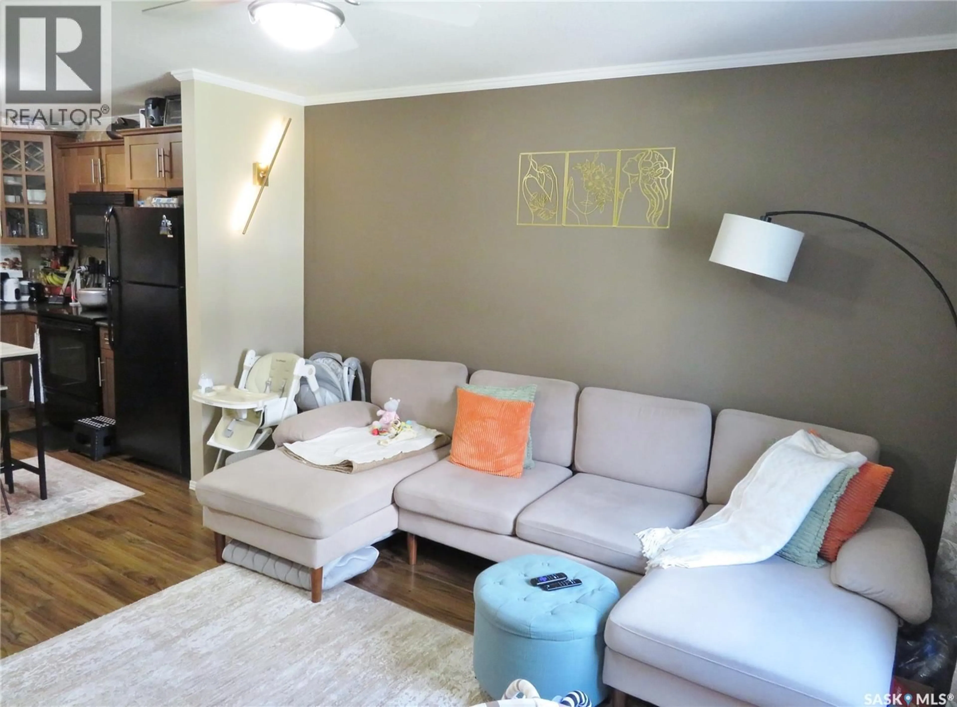 Living room with furniture, wood/laminate floor for 115 - 101 DALGLEISH LINK, Saskatoon Saskatchewan S7W0N5