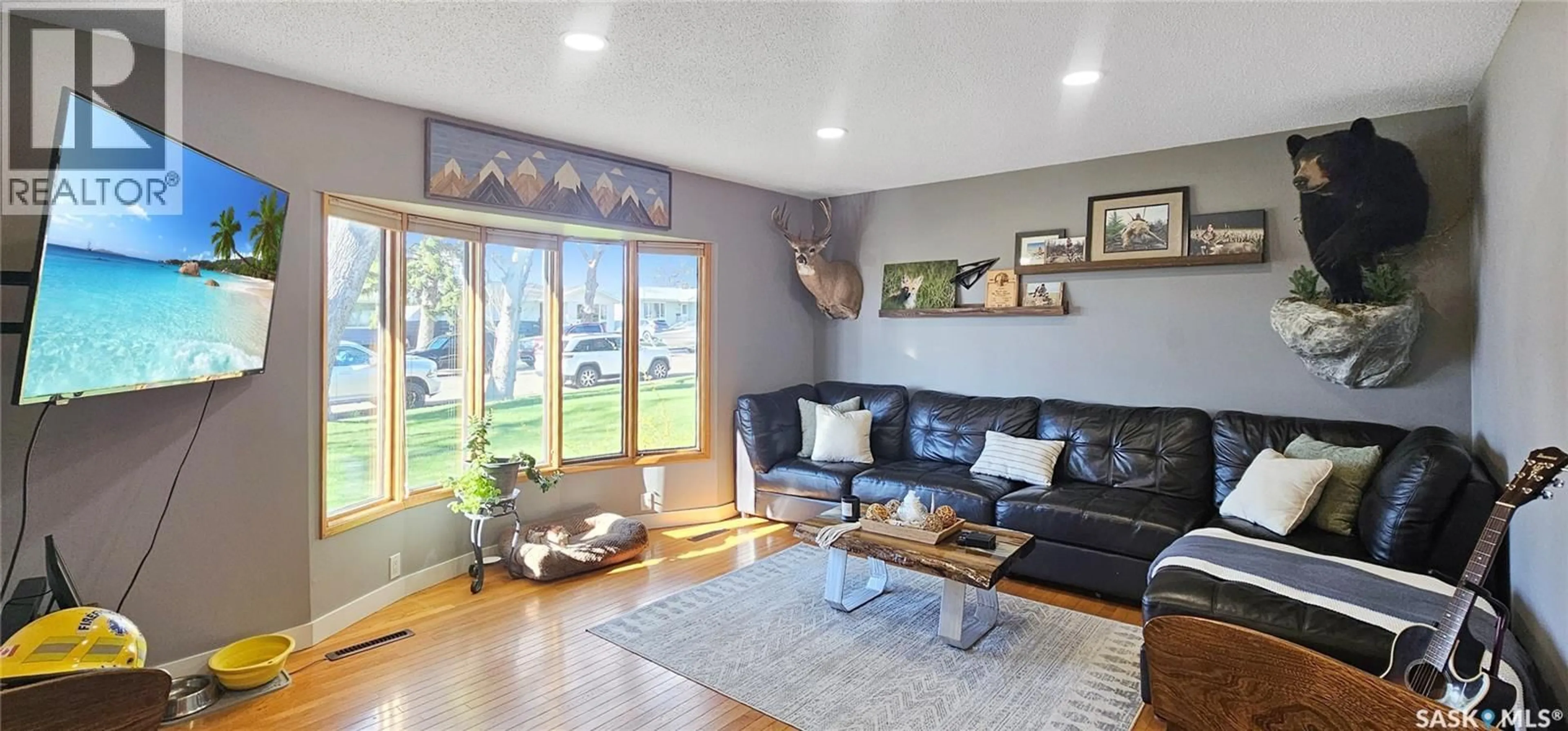 Living room with furniture, wood/laminate floor for 1406 ASHLEY DRIVE, Swift Current Saskatchewan S9H1N5
