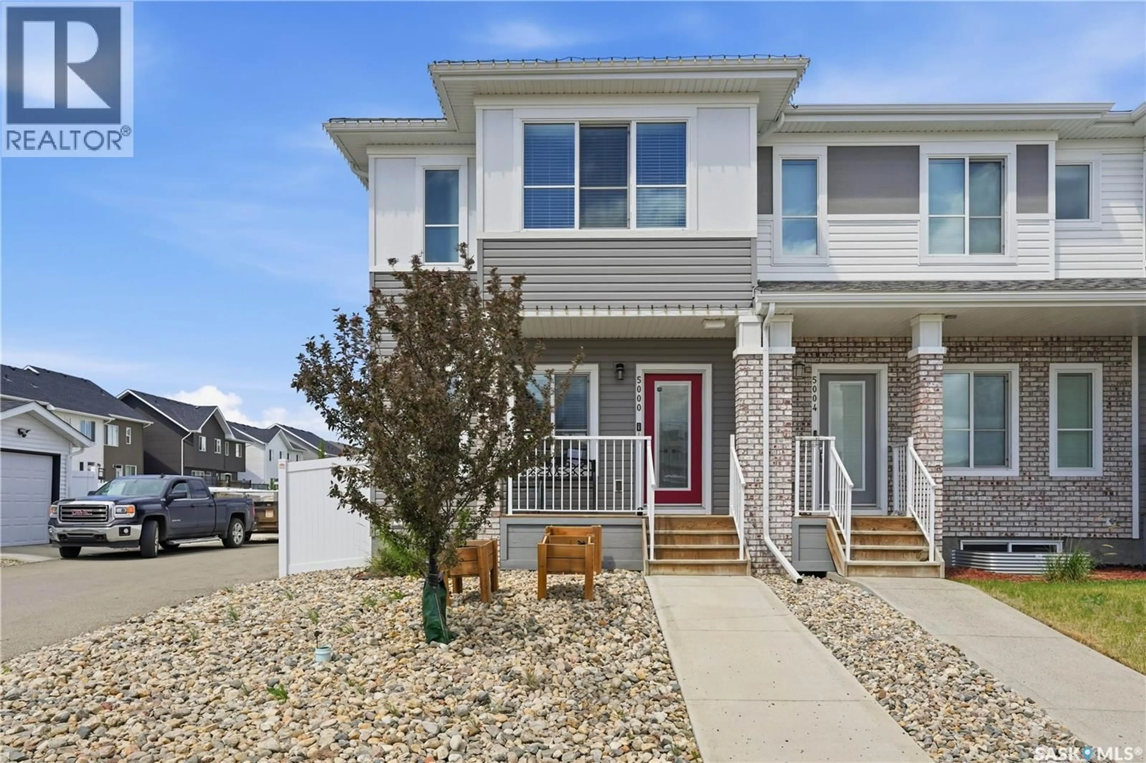 Home with vinyl exterior material, street for E - 5000 PRIMROSE GREEN DRIVE, Regina Saskatchewan S4V2Z6