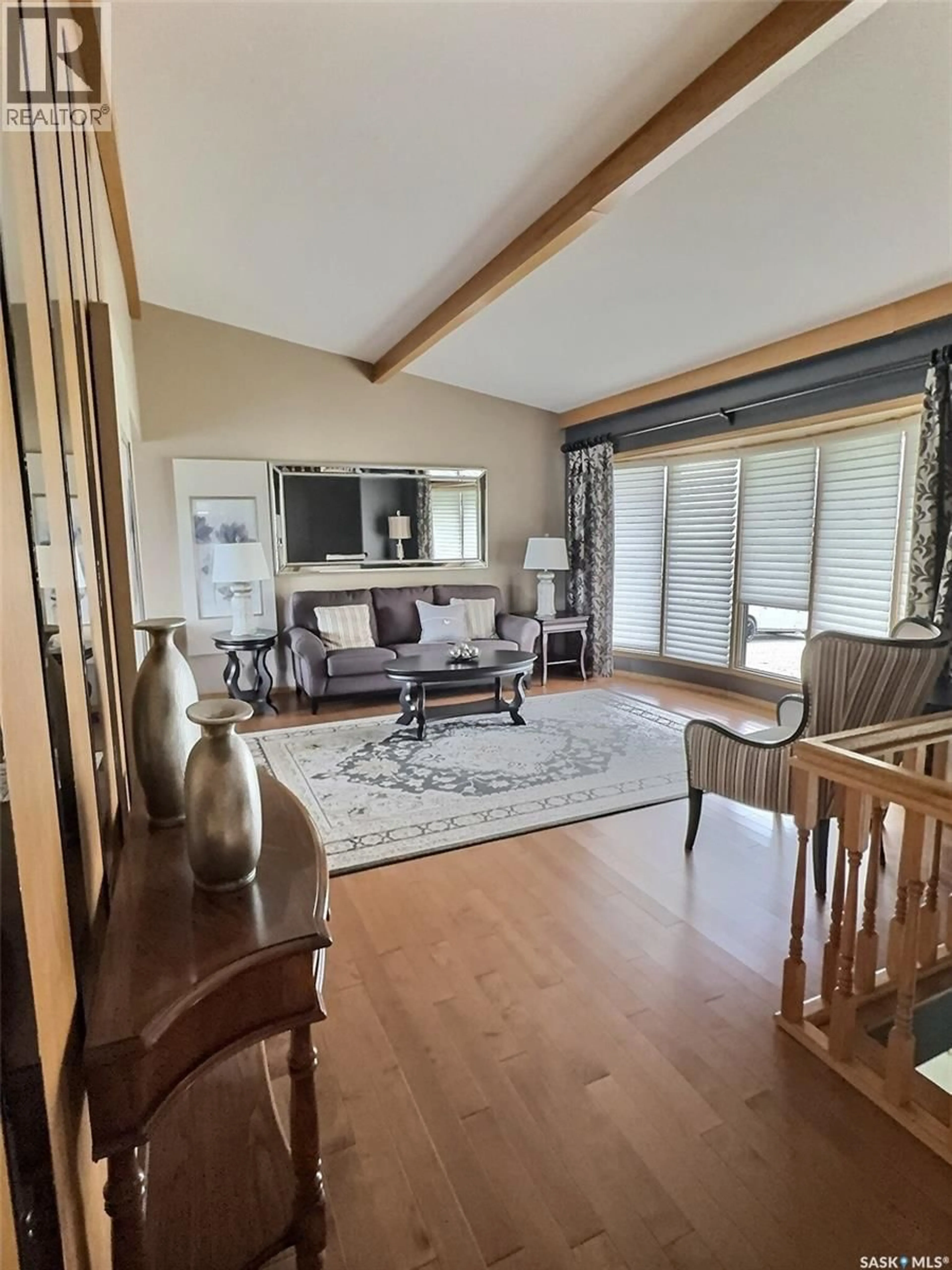 Living room with furniture, wood/laminate floor for 322 SPRUCE DRIVE, Estevan Saskatchewan S4A2G1