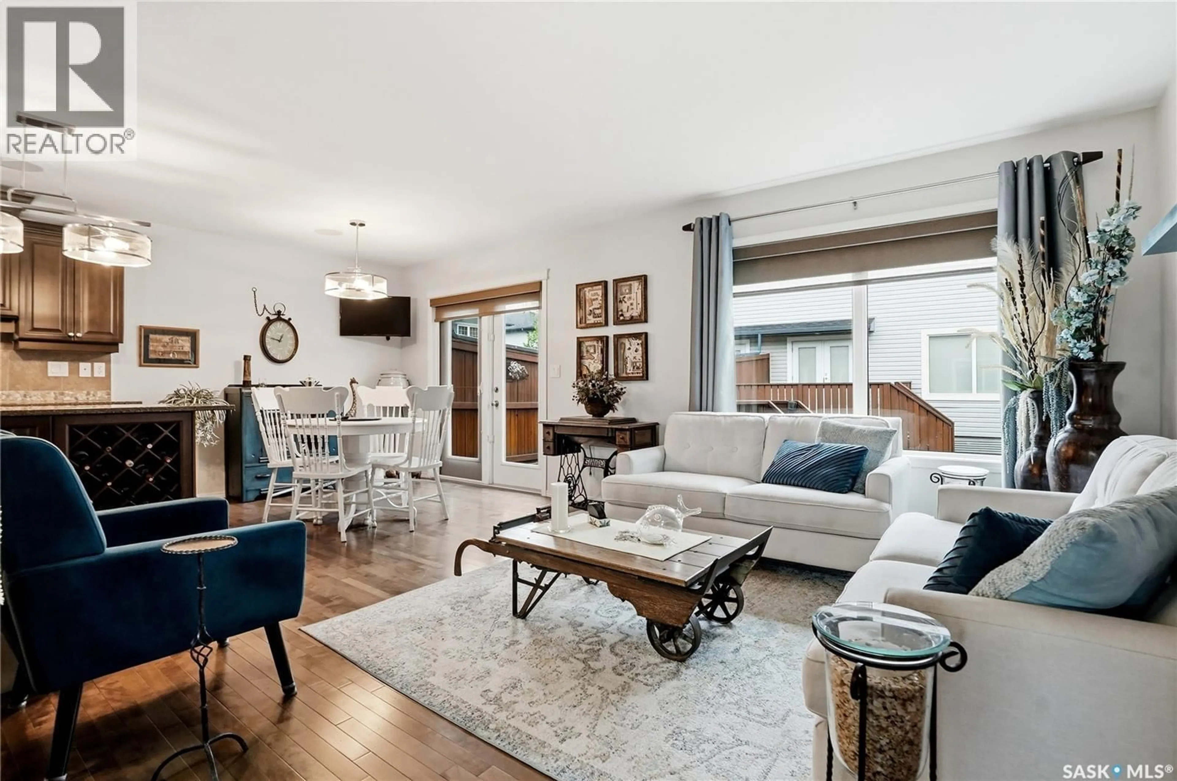 Living room with furniture, wood/laminate floor for 16 110 DULMAGE CRESCENT, Saskatoon Saskatchewan S7T0C7