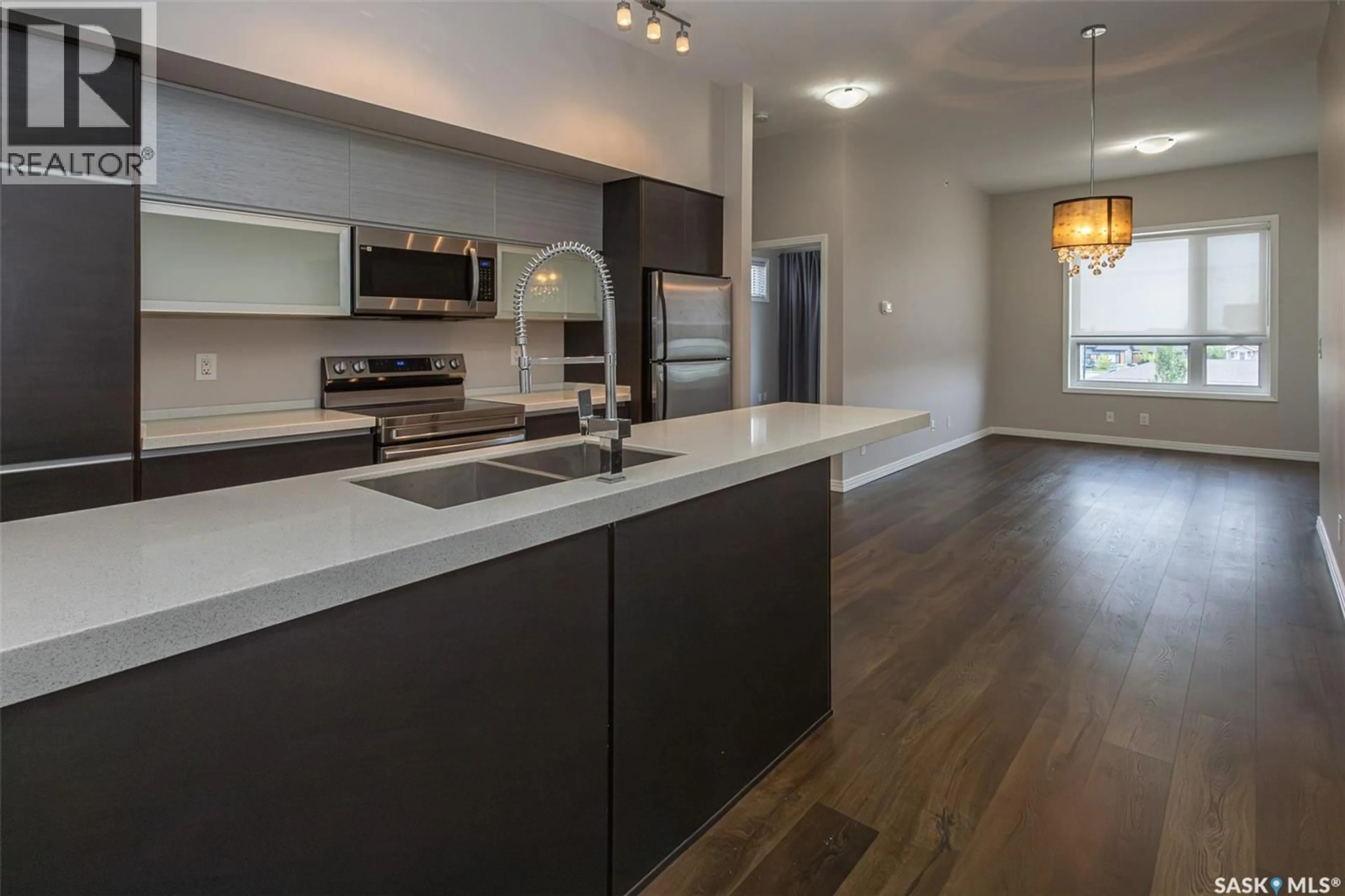 Open concept kitchen, wood/laminate floor for 225 - 307 MANINGAS BEND, Saskatoon Saskatchewan S7W0P9