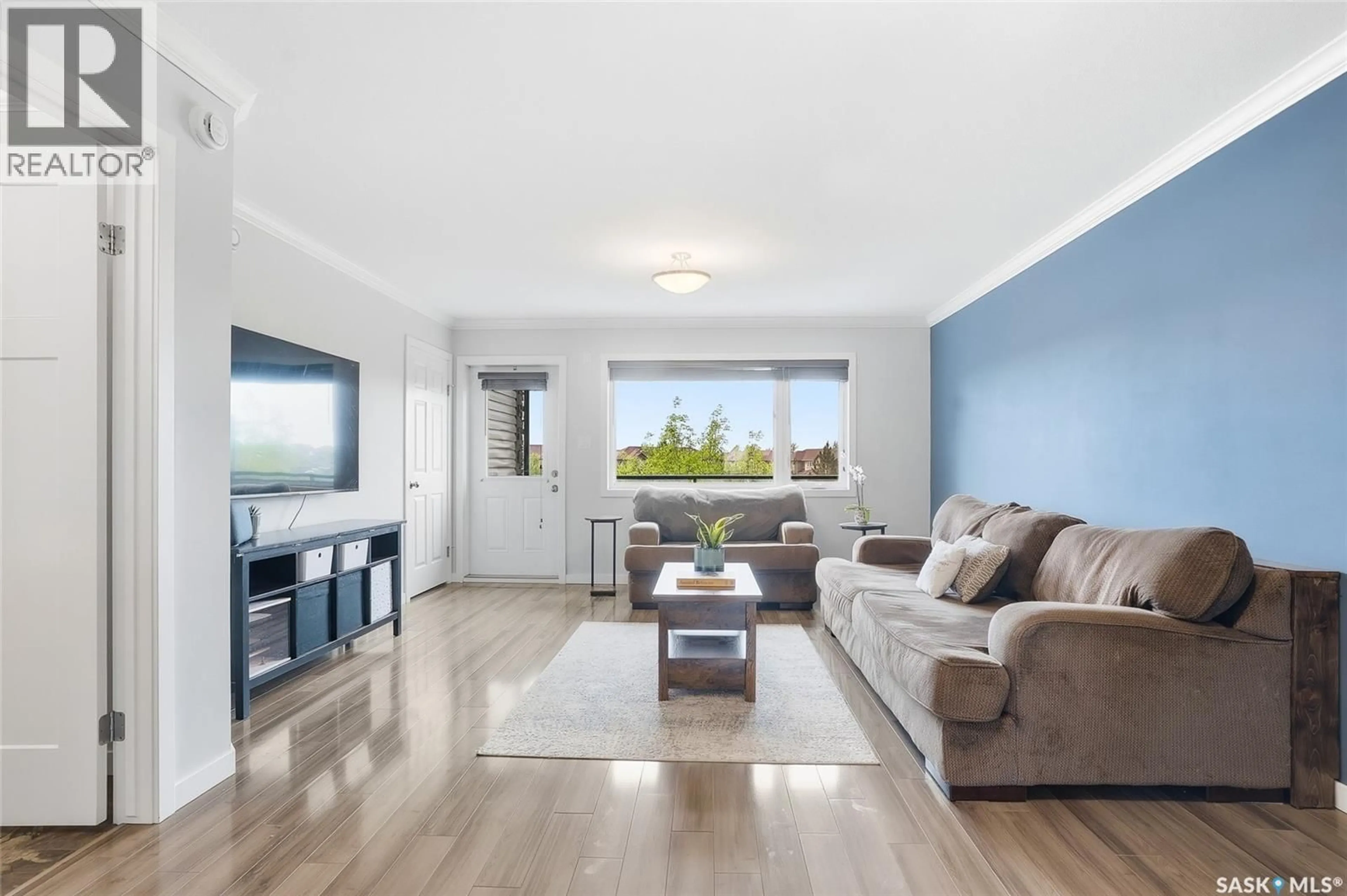 Living room with furniture, wood/laminate floor for 370 620 CORNISH ROAD, Saskatoon Saskatchewan S7T0Y3