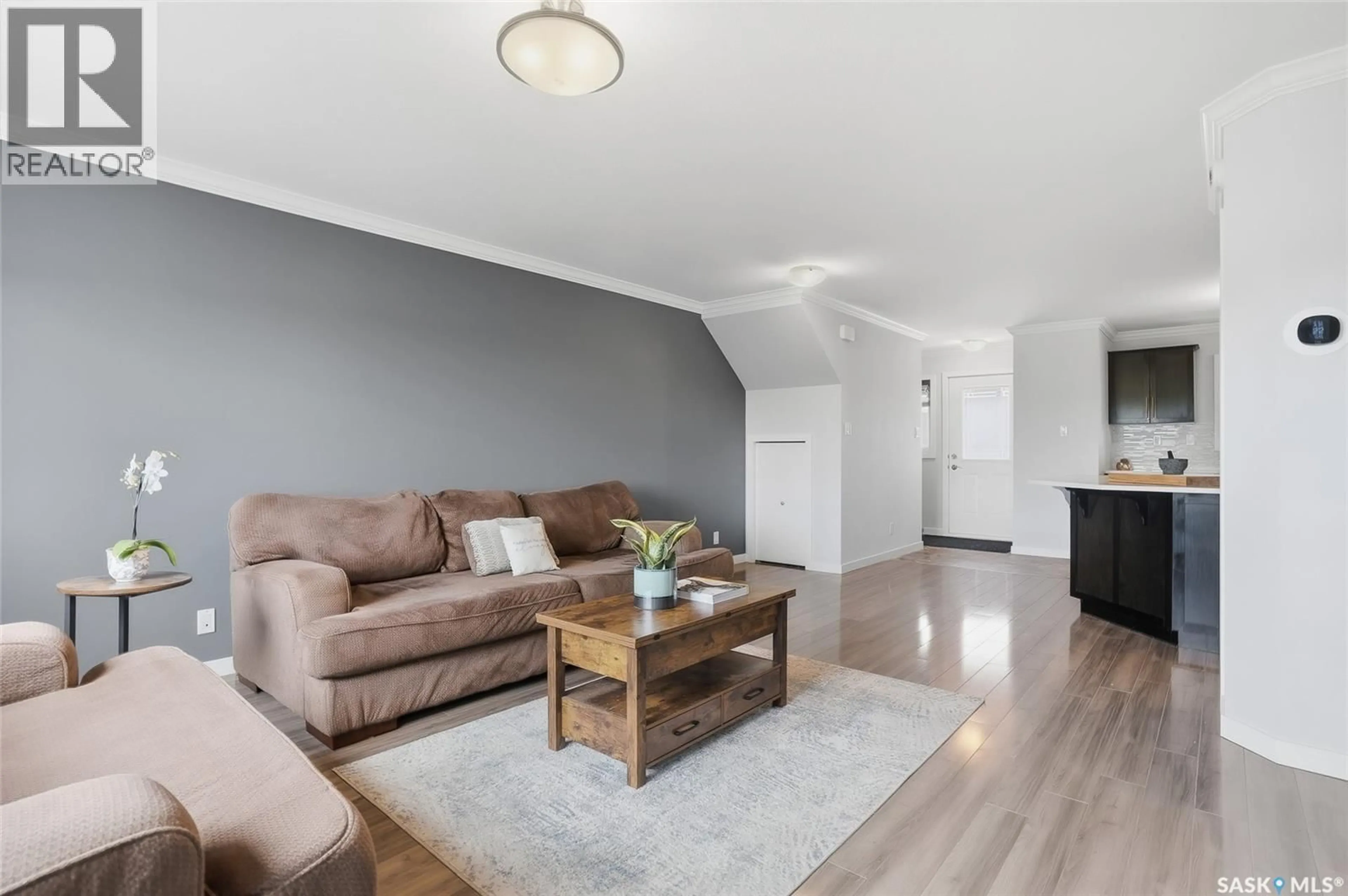 Living room with furniture, wood/laminate floor for 370 620 CORNISH ROAD, Saskatoon Saskatchewan S7T0Y3
