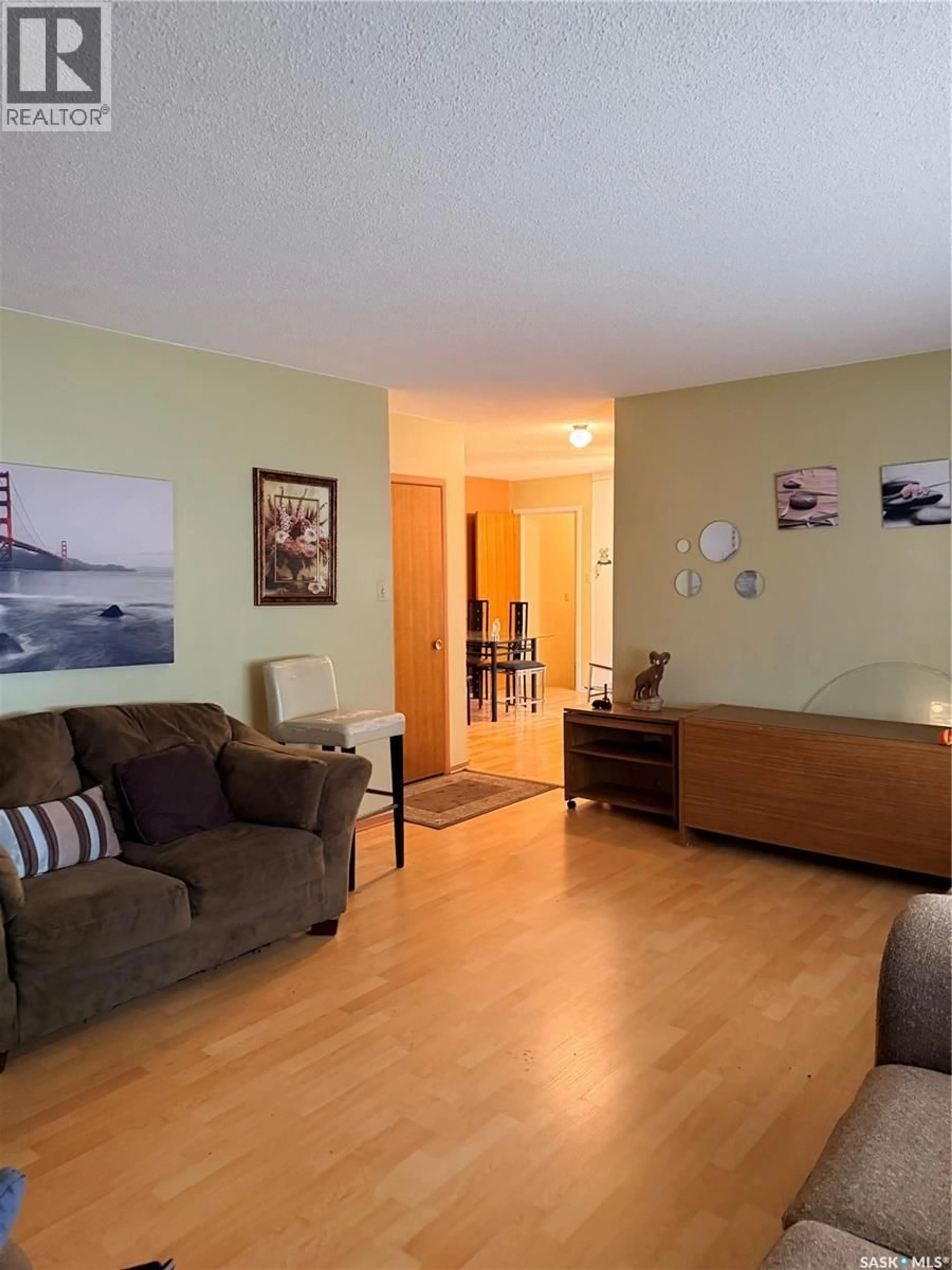 Living room with furniture, wood/laminate floor for 512 MCNAB STREET, Burstall Saskatchewan S0N0H0