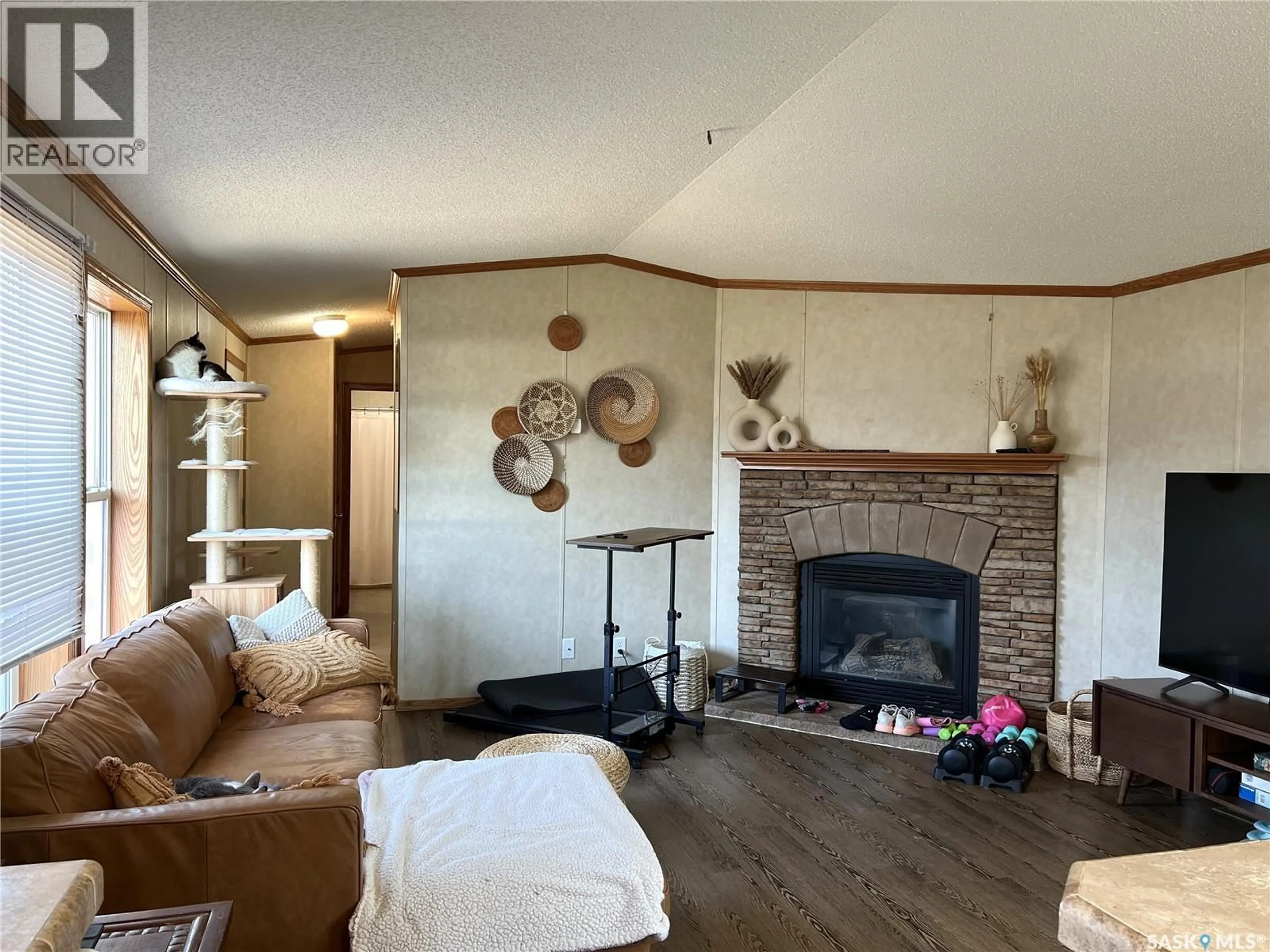 Living room with furniture, wood/laminate floor for 609 6TH STREET, Meadow Lake Saskatchewan S9X1X9