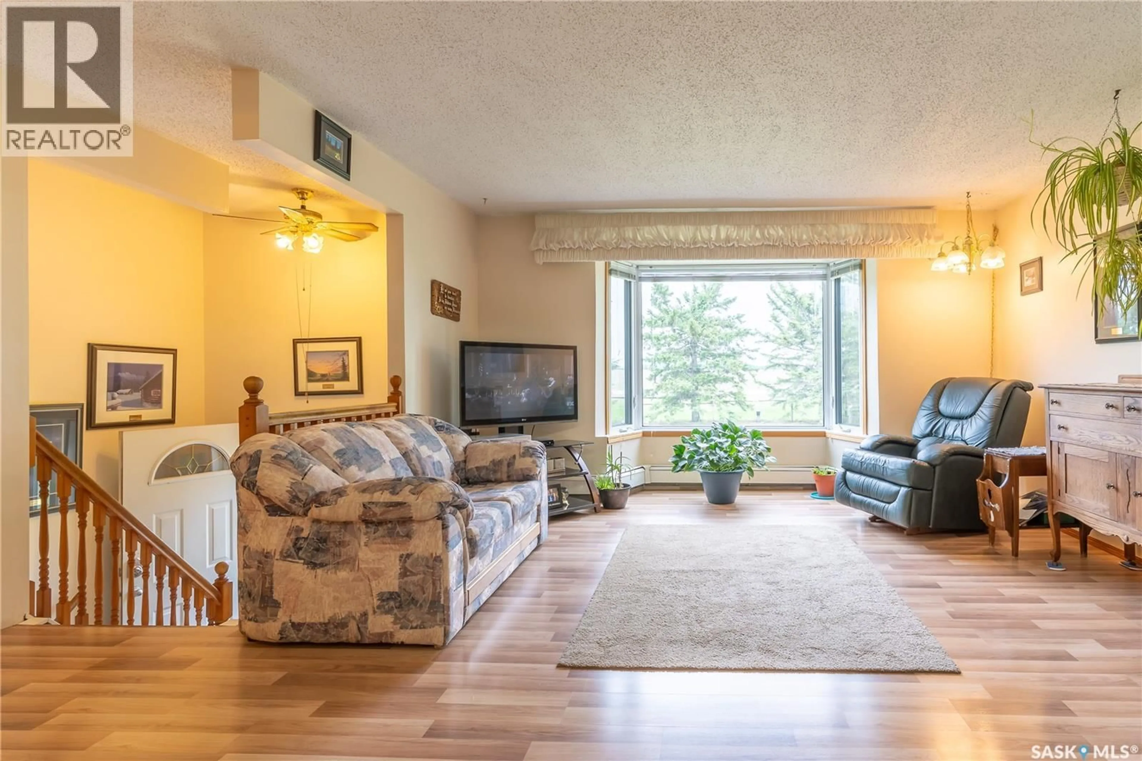 Living room with furniture, wood/laminate floor for CALLFAS ACREAGE, Rosthern Rm No. 403 Saskatchewan S0K3R0
