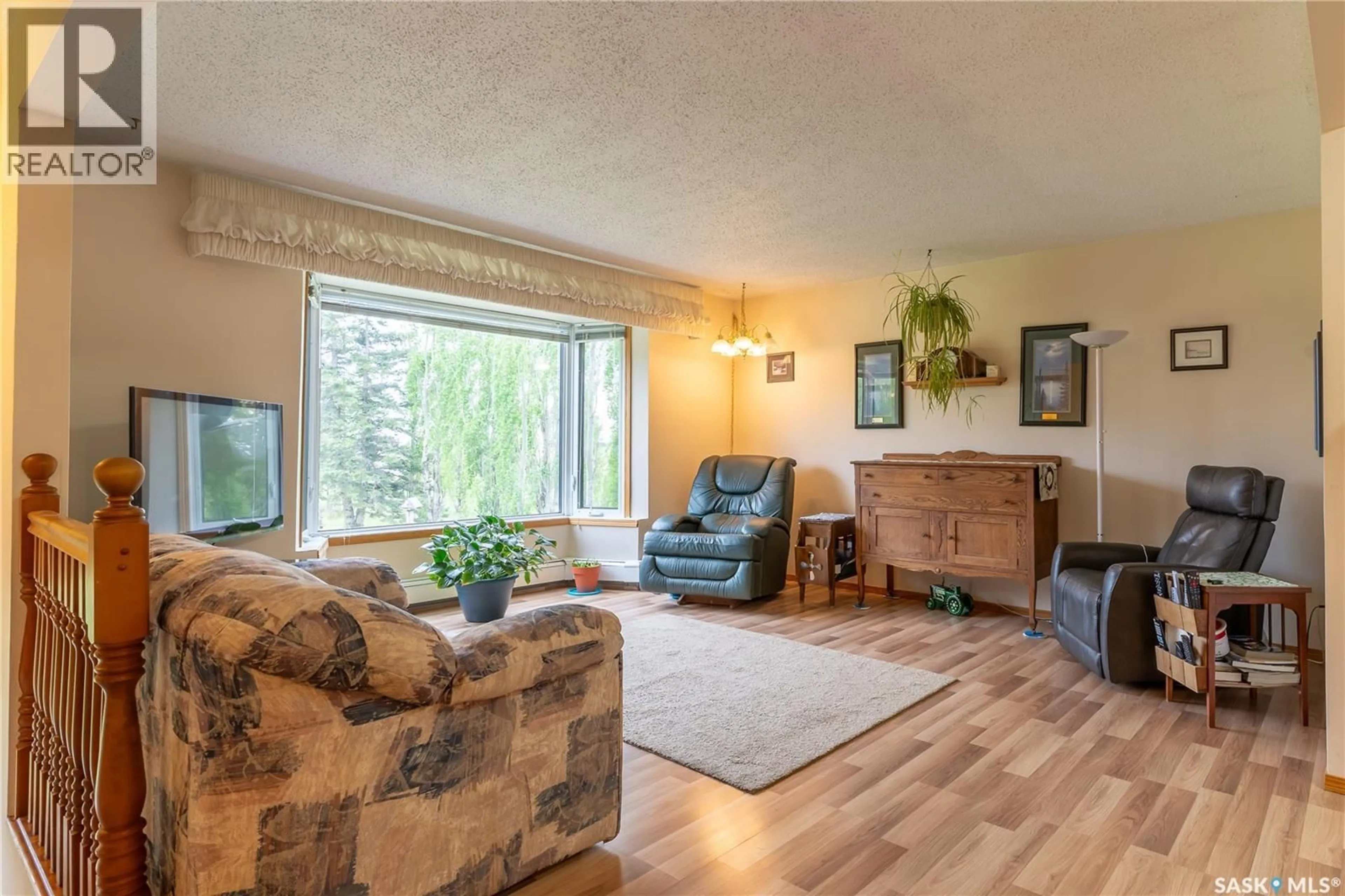 Living room with furniture, wood/laminate floor for CALLFAS ACREAGE, Rosthern Rm No. 403 Saskatchewan S0K3R0