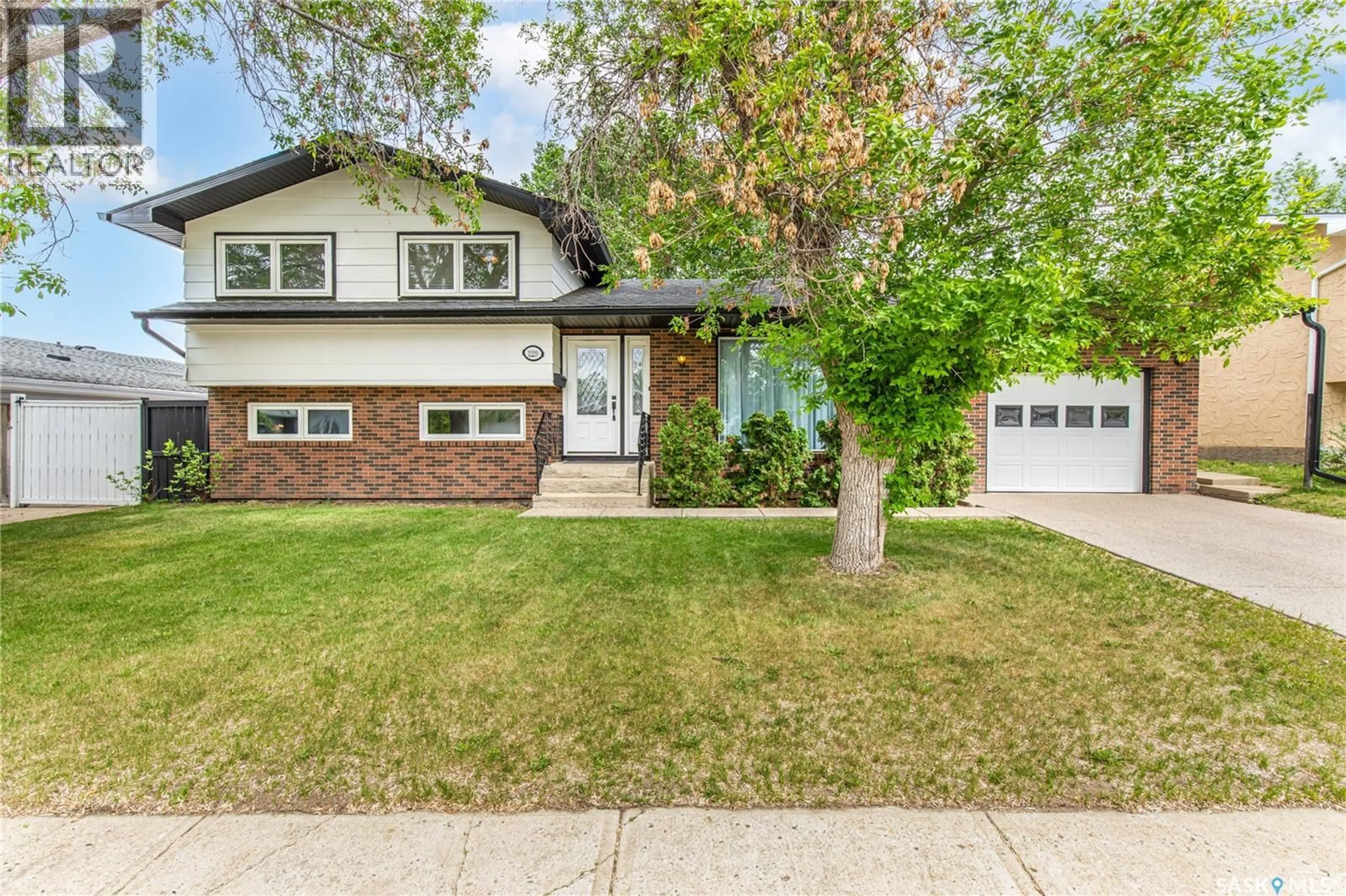 Home with vinyl exterior material, street for 1229 PASCOE DRIVE, Moose Jaw Saskatchewan S6H6Z4