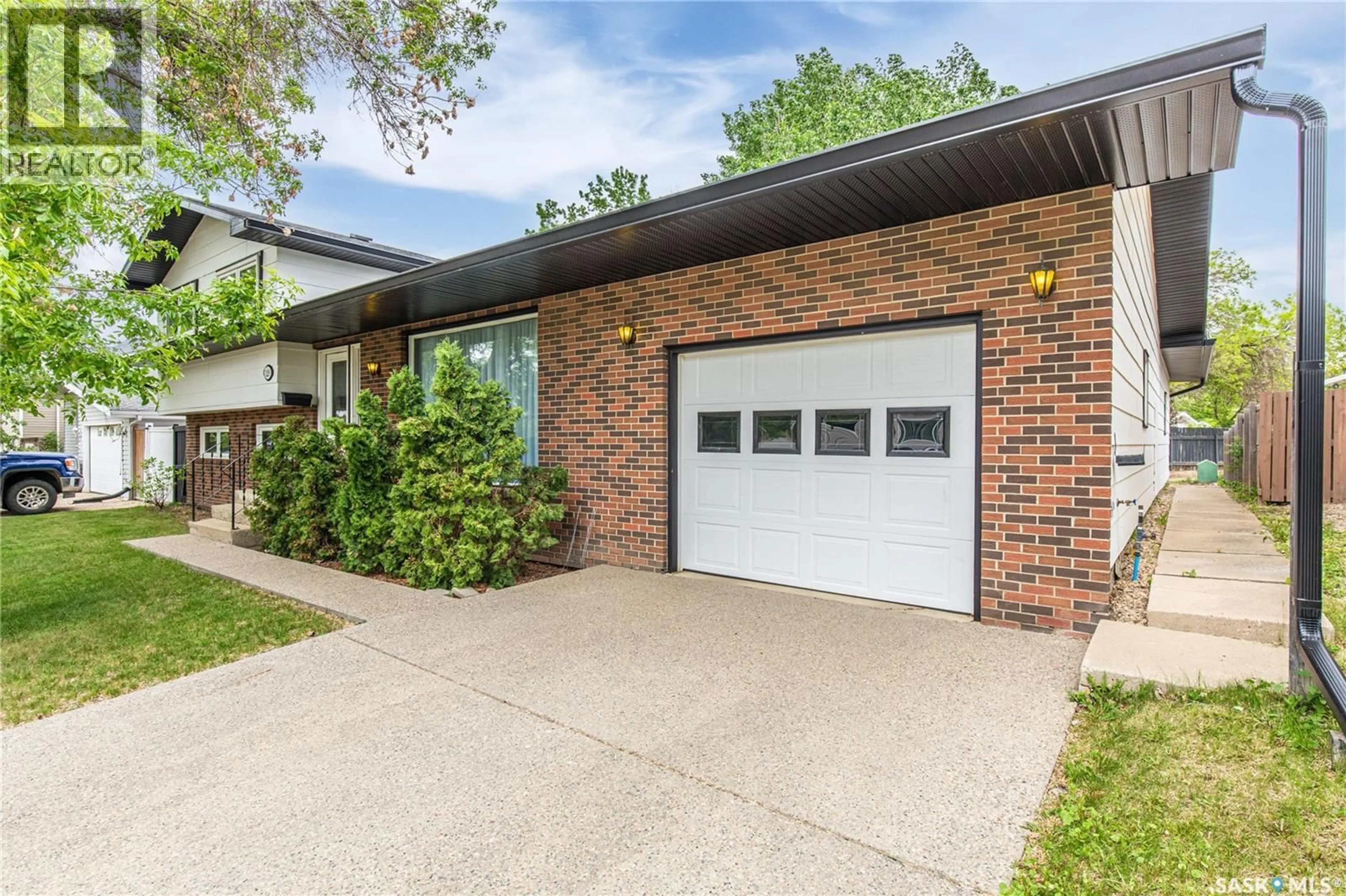 Home with brick exterior material, street for 1229 PASCOE DRIVE, Moose Jaw Saskatchewan S6H6Z4