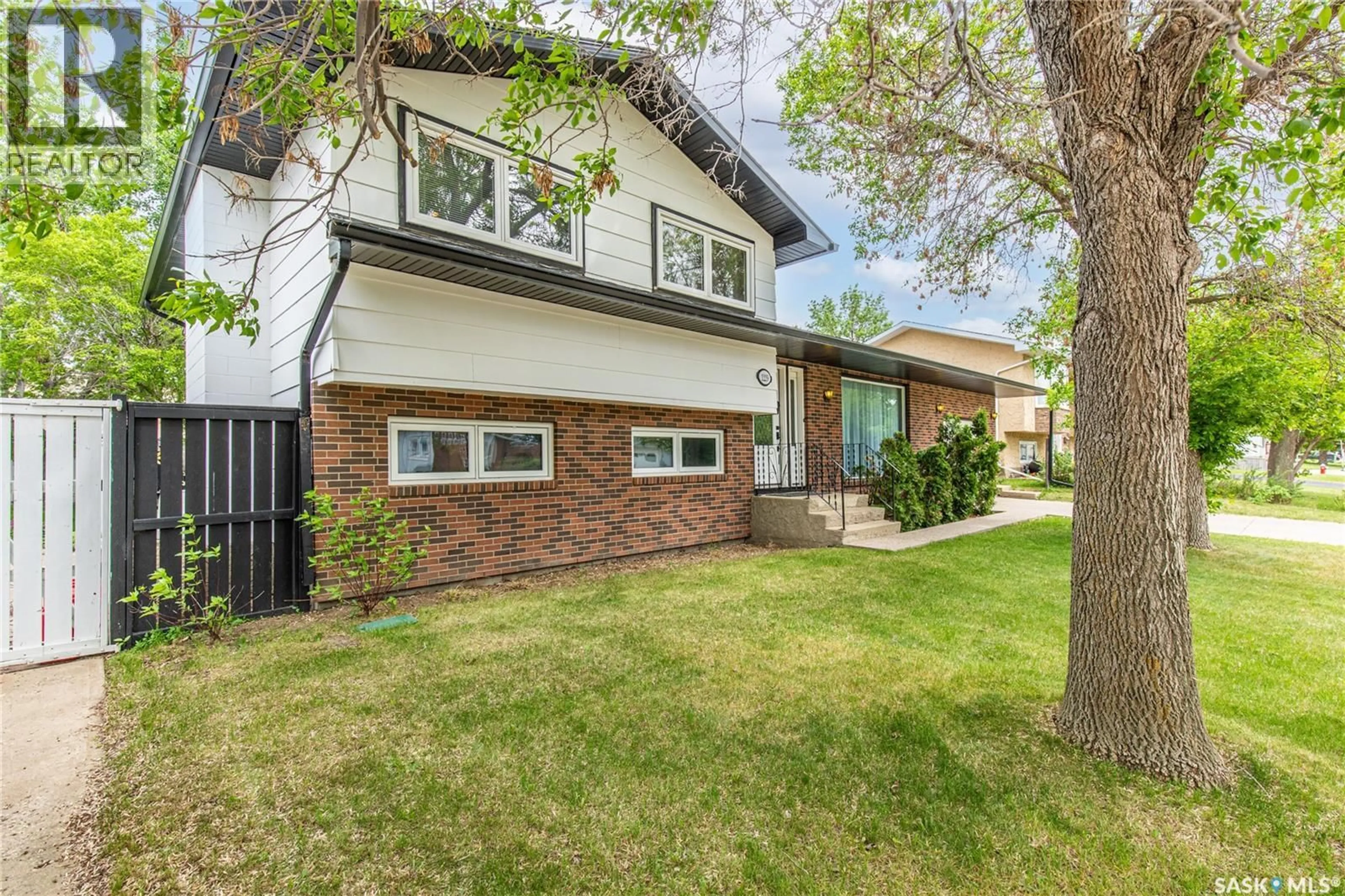 Home with brick exterior material, street for 1229 PASCOE DRIVE, Moose Jaw Saskatchewan S6H6Z4