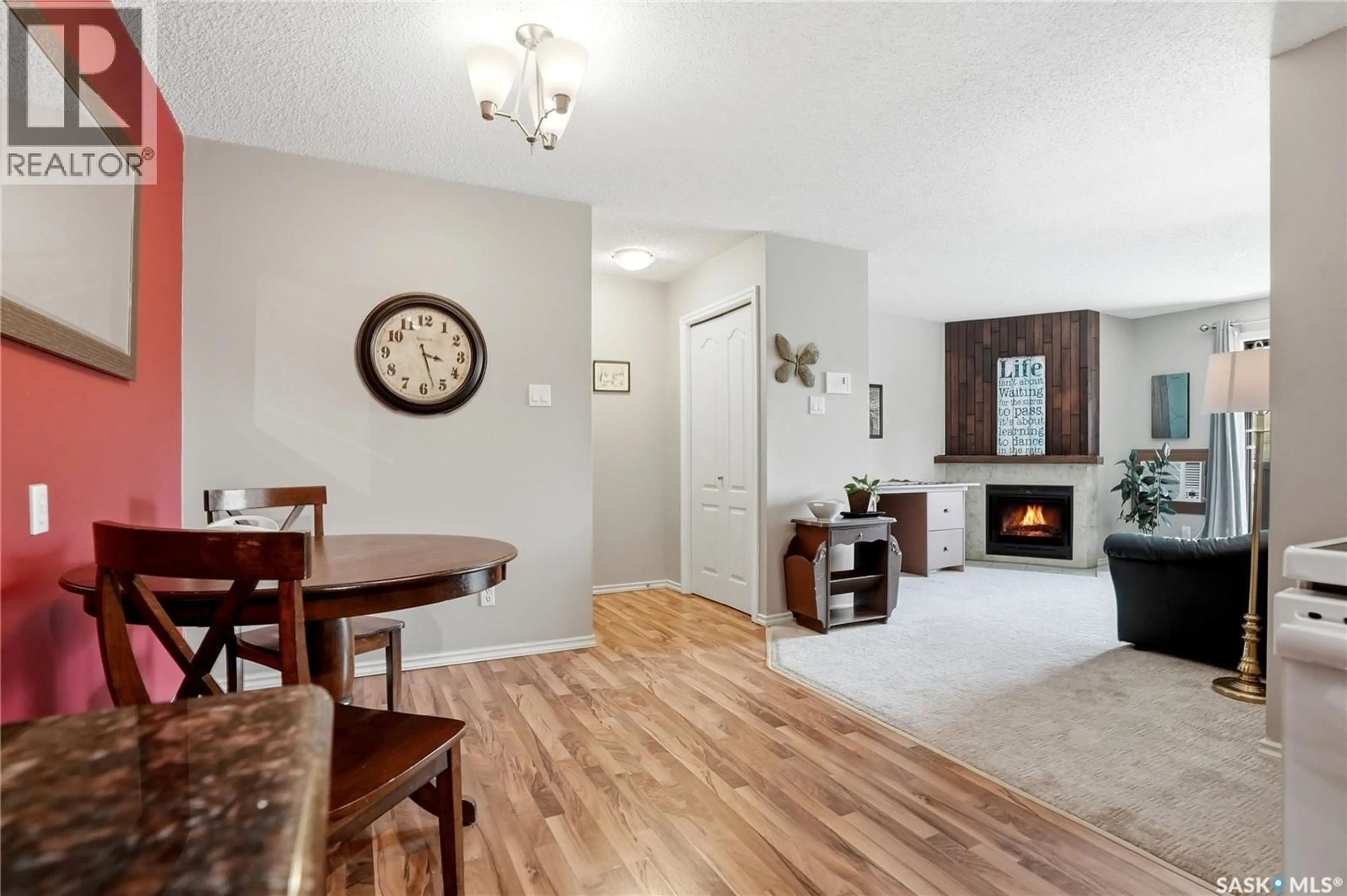Living room with furniture, wood/laminate floor for 201D2 - 1121 MCKERCHER DRIVE, Saskatoon Saskatchewan S7H5B8