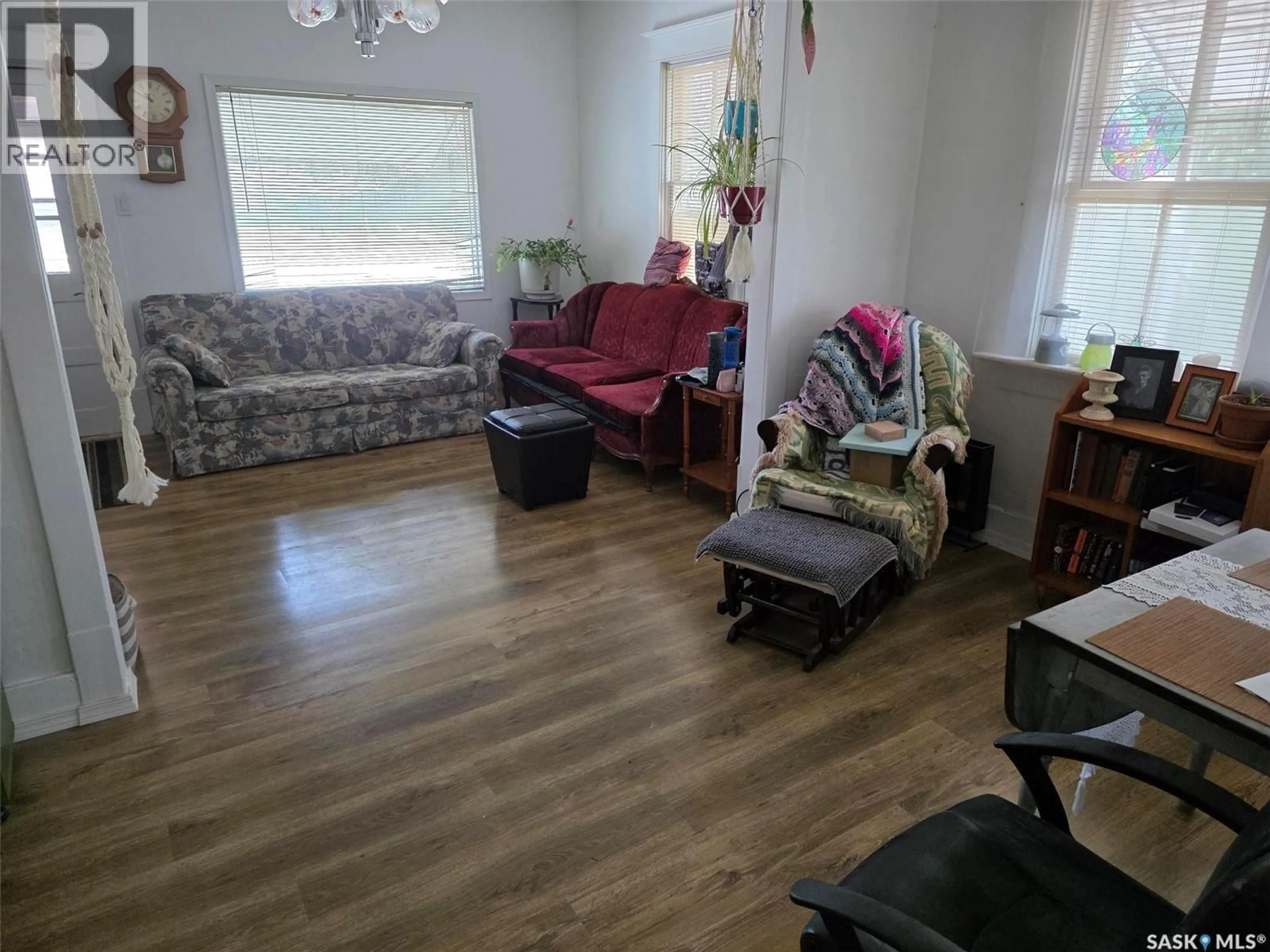 Living room with furniture, wood/laminate floor for 4904 TRIBUNE STREET, Macklin Saskatchewan S0L2C0