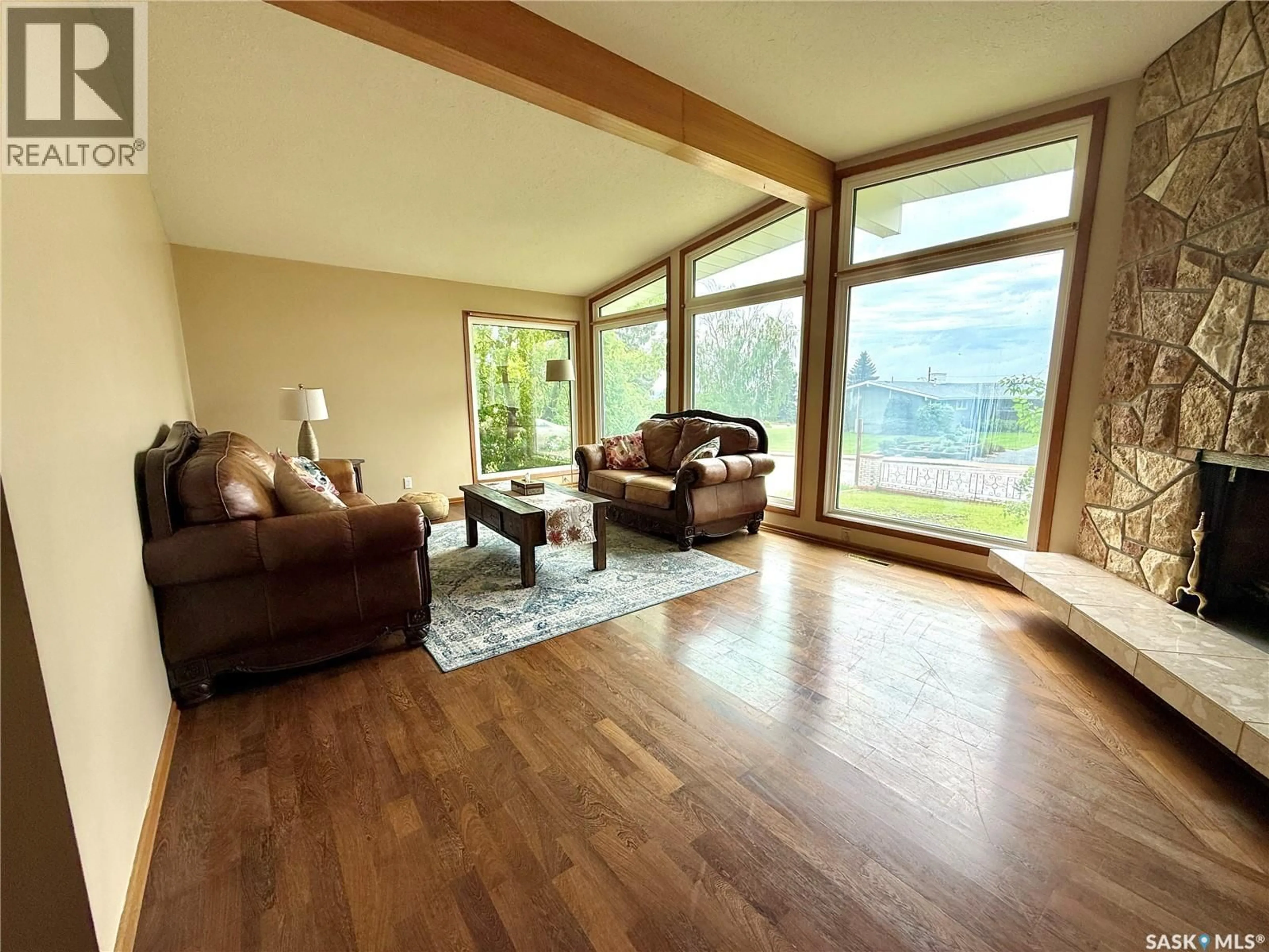 Living room with furniture, wood/laminate floor for 522 100TH STREET, North Battleford Saskatchewan S9A0T4