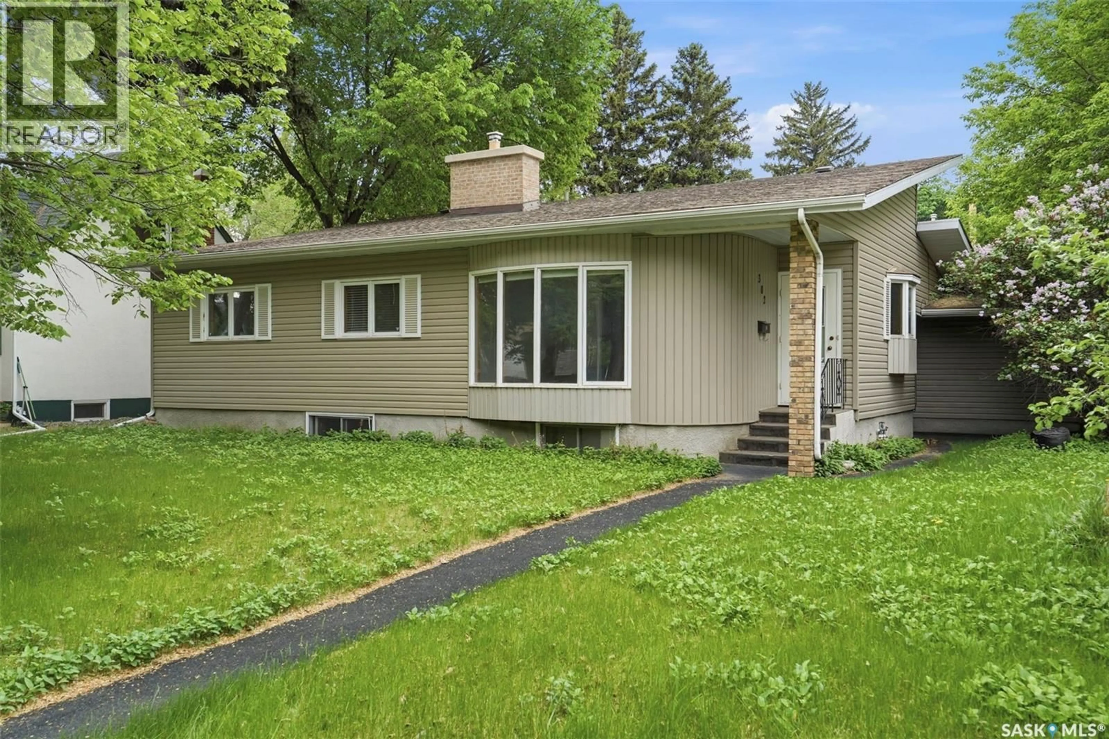 Home with vinyl exterior material, street for 302 MCKINNON AVENUE, Saskatoon Saskatchewan S7N1J5