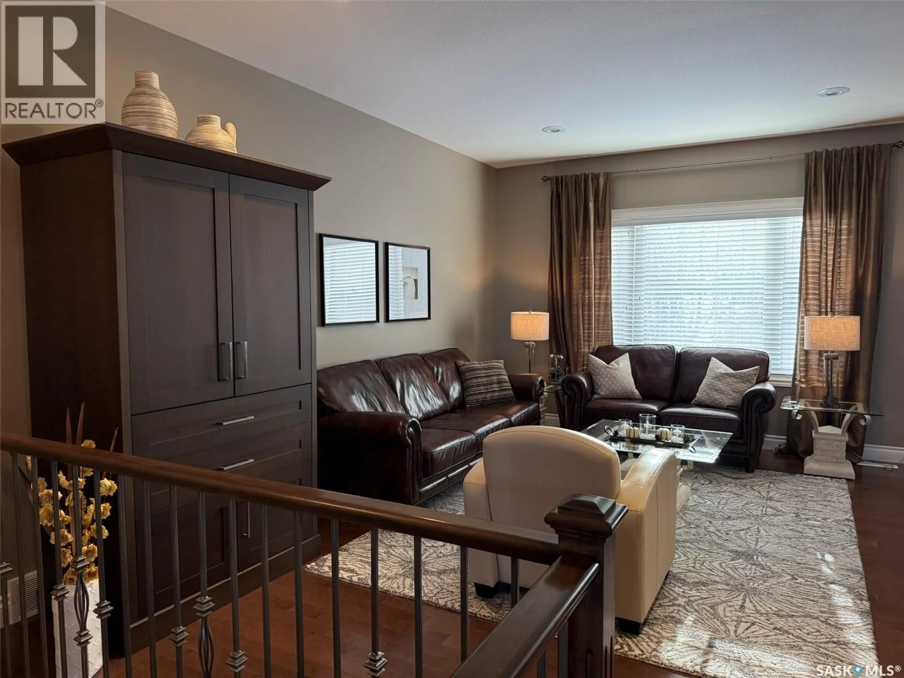 Living room with furniture, wood/laminate floor for 11 - 301 CARTWRIGHT TERRACE, Saskatoon Saskatchewan S7T1E2