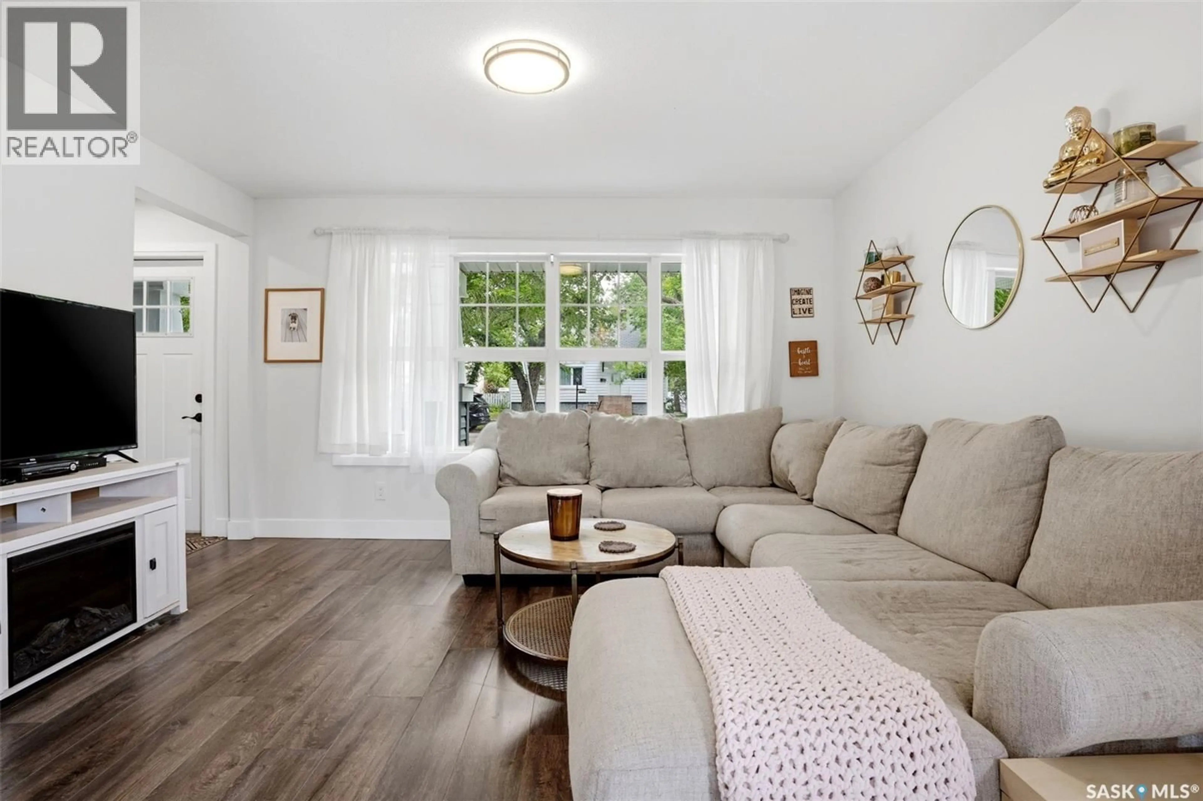Living room with furniture, wood/laminate floor for 1030 CONNAUGHT AVENUE, Moose Jaw Saskatchewan S6H4B5