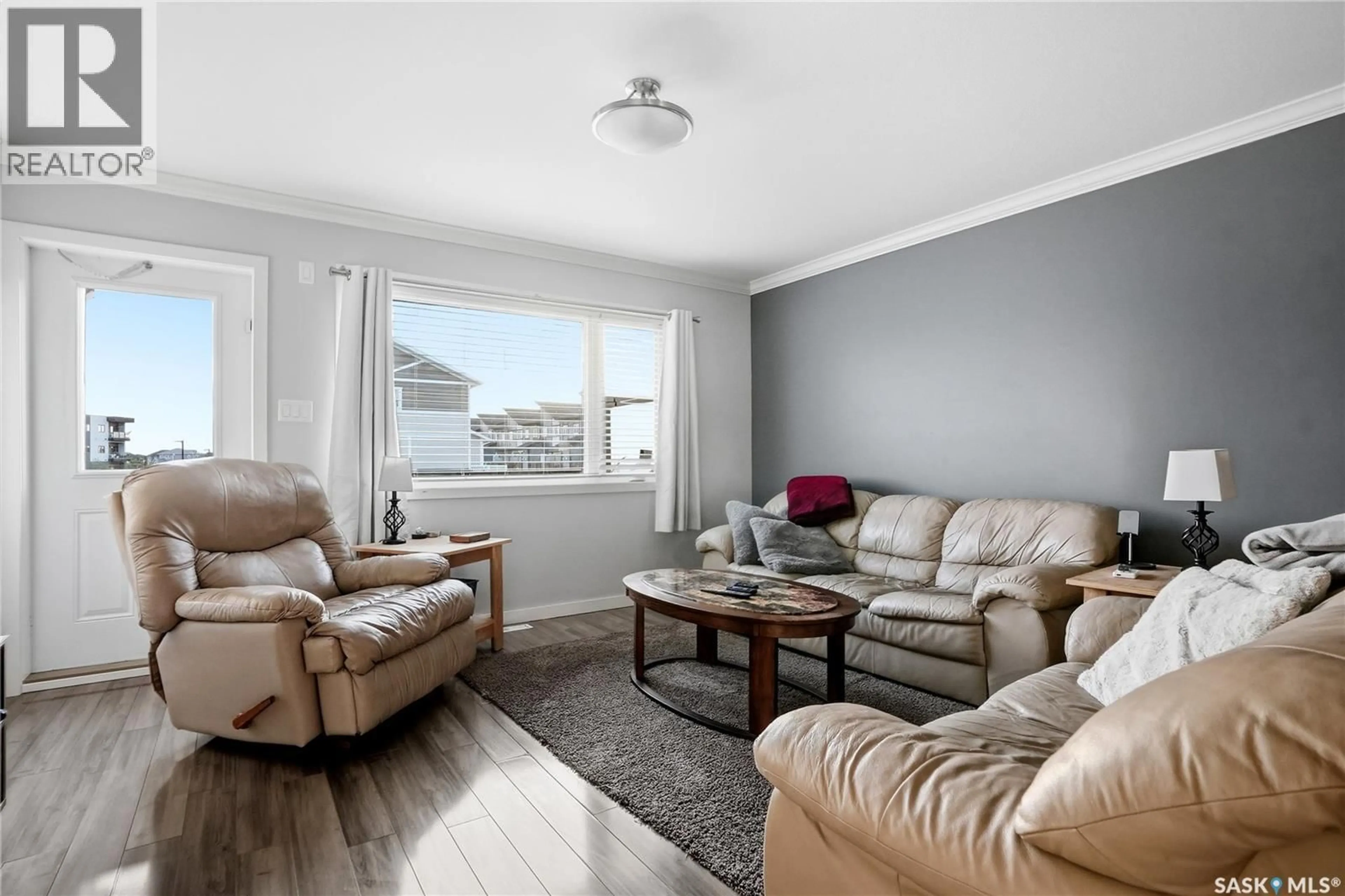Living room with furniture, wood/laminate floor for 250 - 253 AKHTAR BEND, Saskatoon Saskatchewan S7W0W4