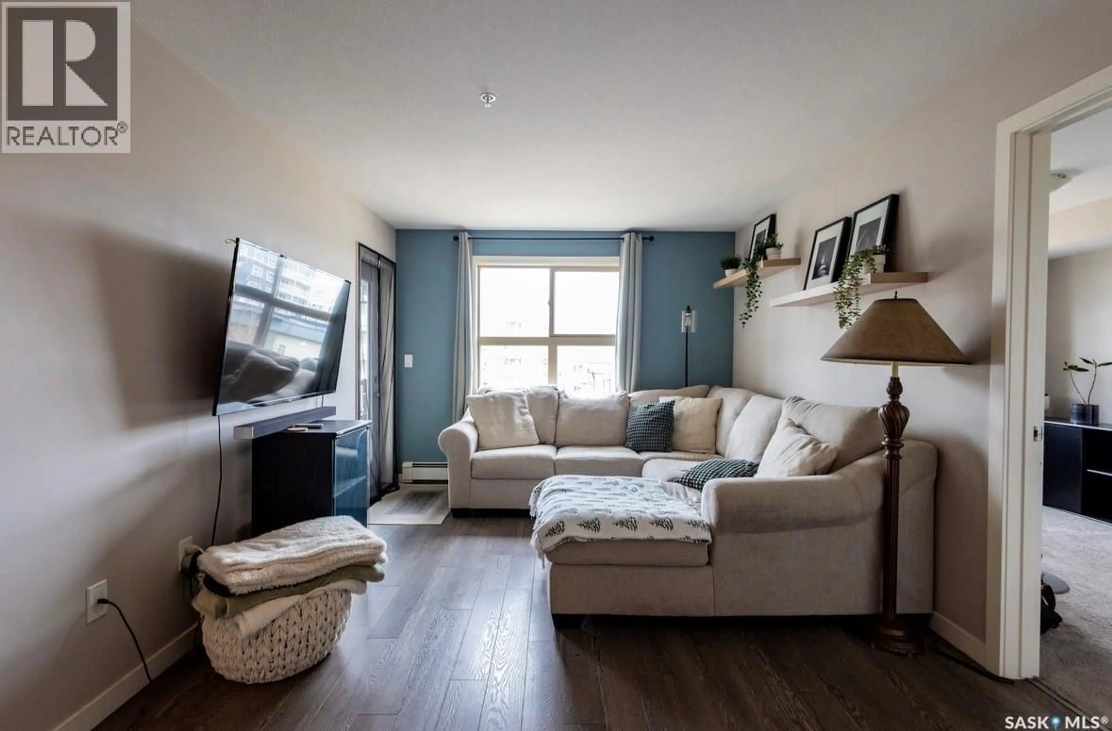 Living room with furniture, wood/laminate floor for 5500 - 2303 MITCHINSON WAY, Regina Saskatchewan S4W0N9