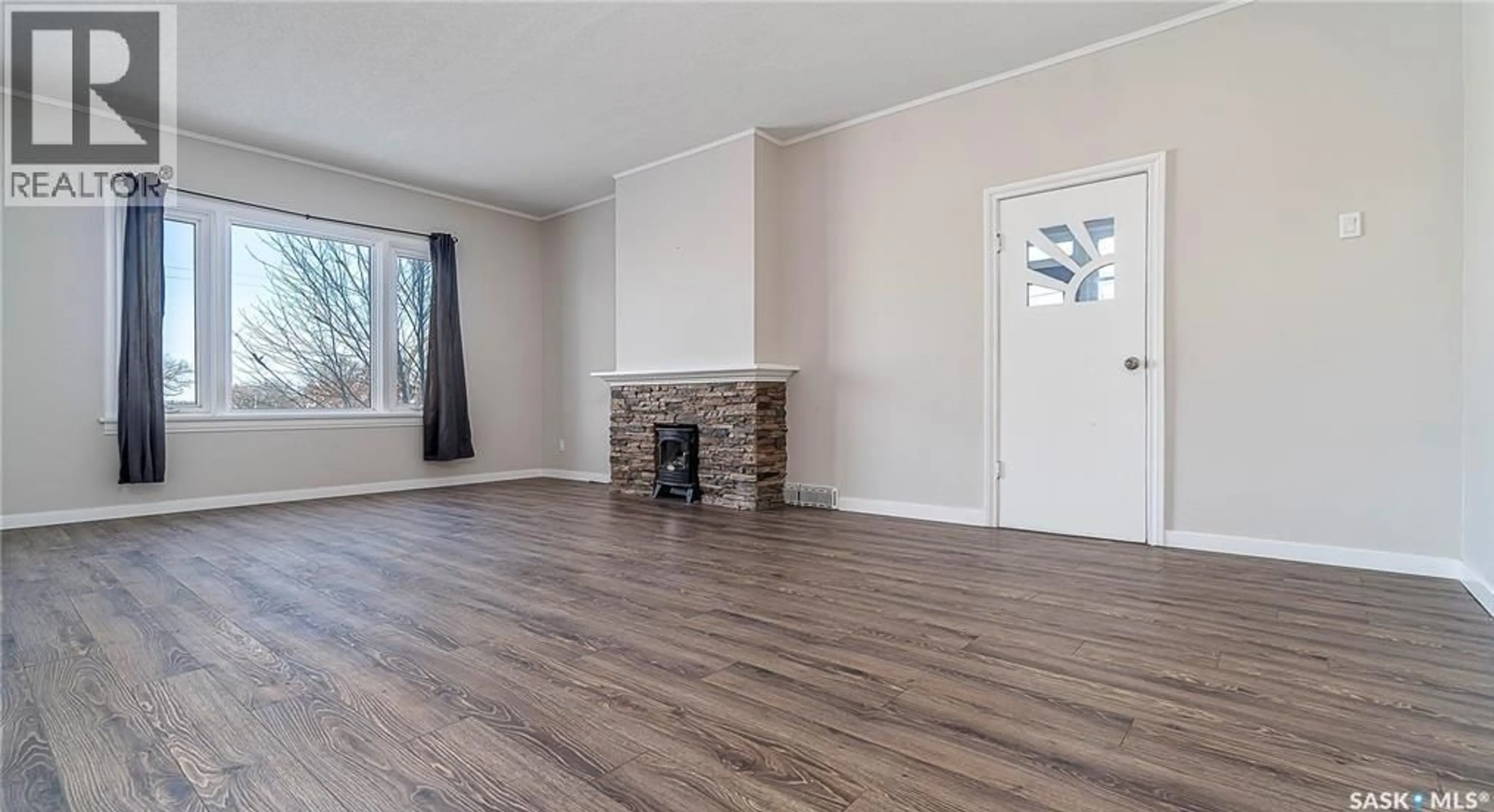Living room with furniture, wood/laminate floor for 79 COTEAU STREET E, Moose Jaw Saskatchewan S6H4T4