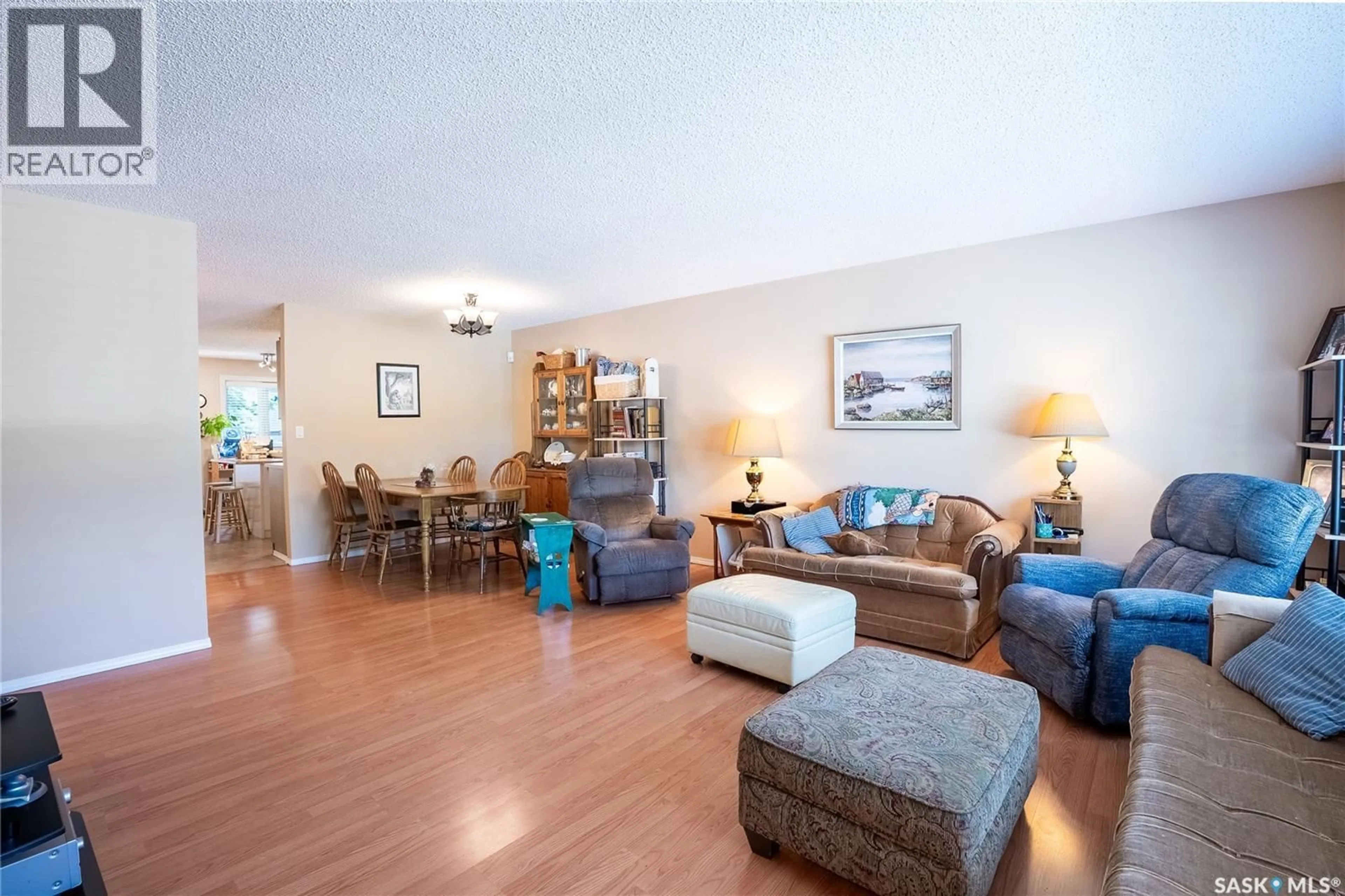 Living room with furniture, wood/laminate floor for 440 2510 KENDERDINE ROAD, Saskatoon Saskatchewan S7N4G5