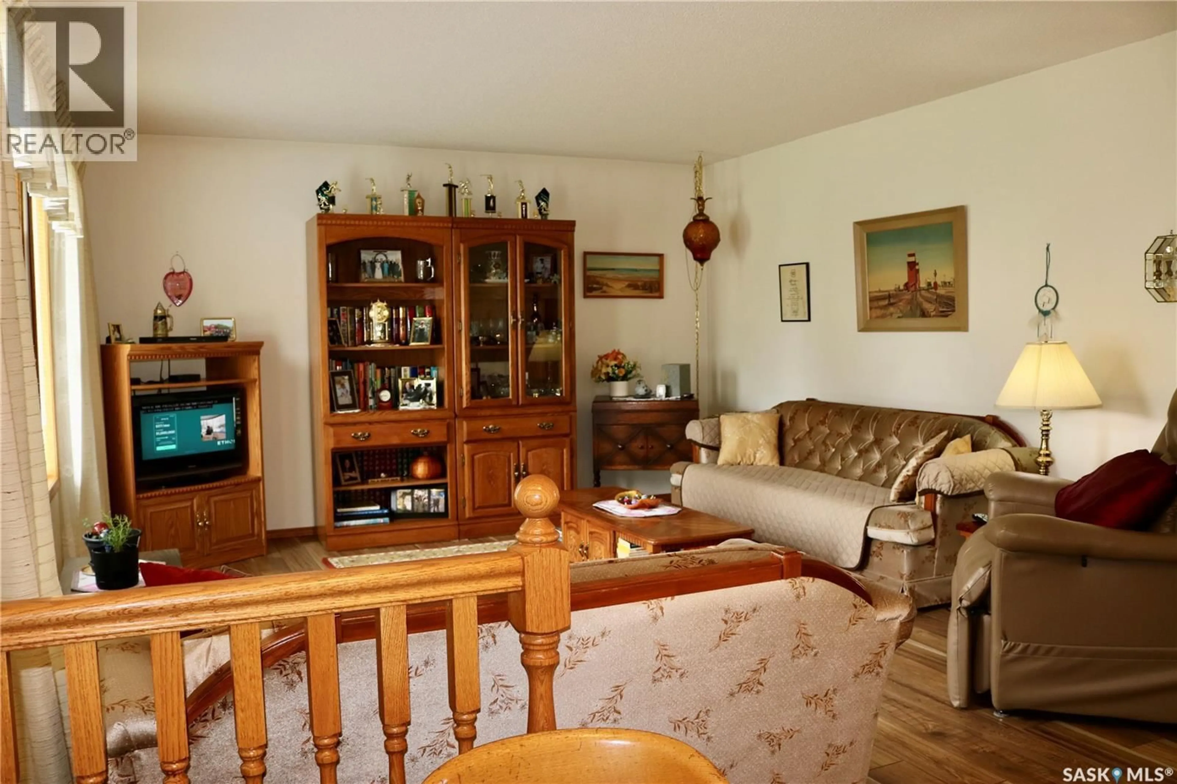 Living room with furniture, wood/laminate floor for 126 MOOSE MOUNTAIN PLACE, Moosomin Saskatchewan S0G3N0