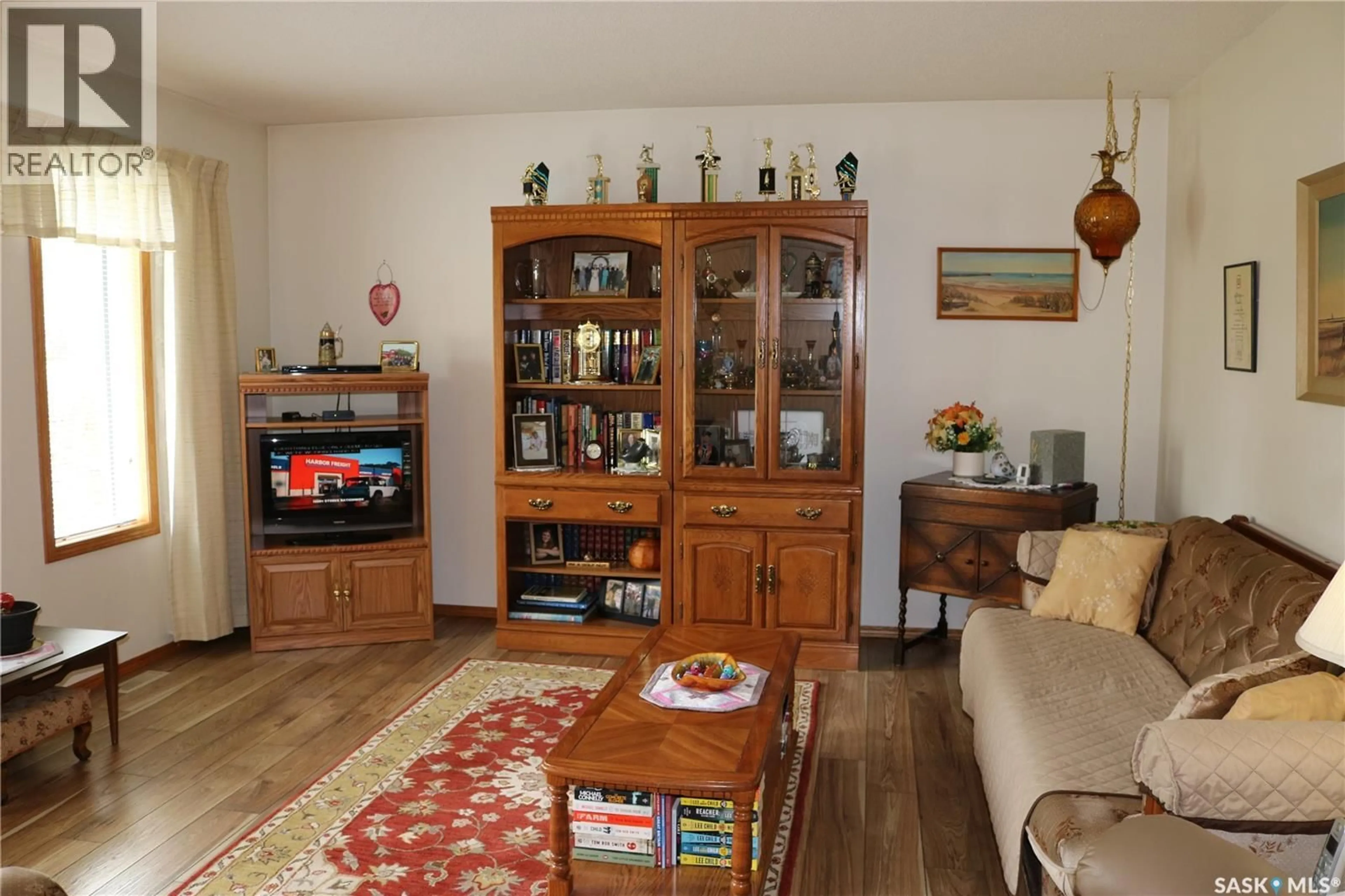 Living room with furniture, wood/laminate floor for 126 MOOSE MOUNTAIN PLACE, Moosomin Saskatchewan S0G3N0