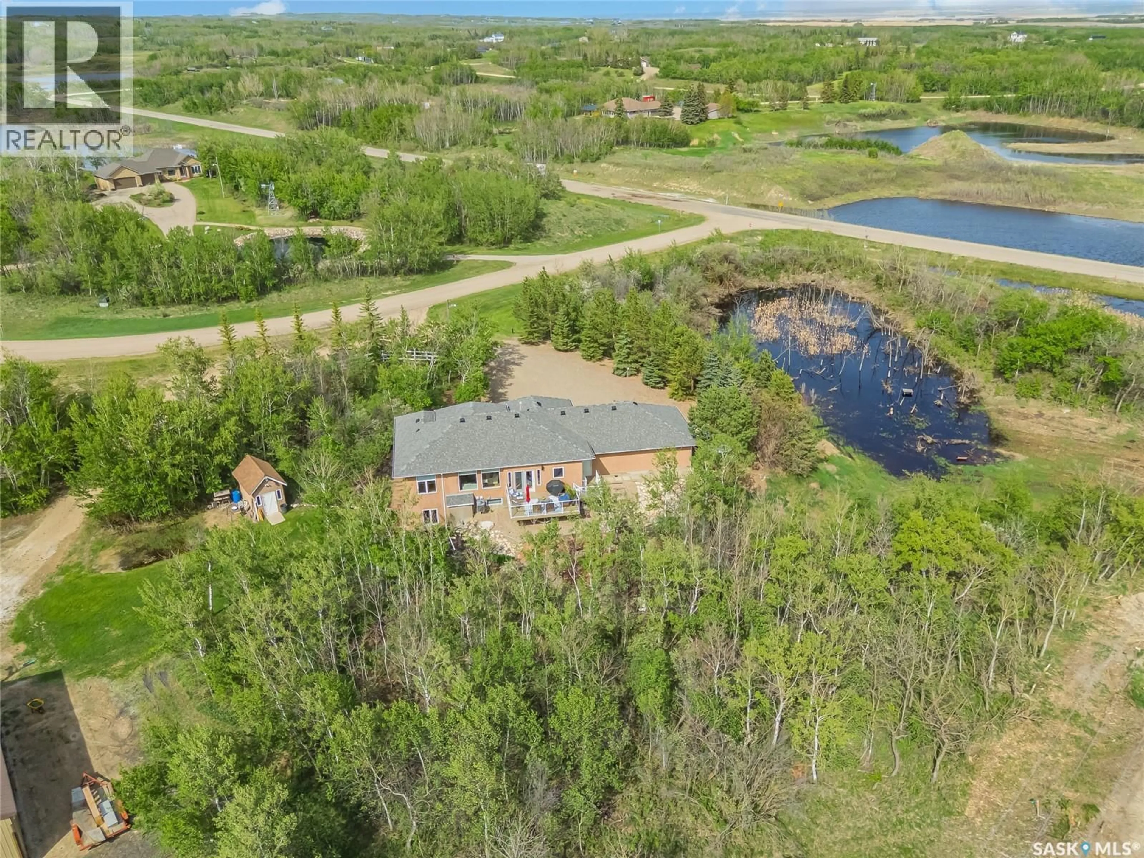 A pic from outside/outdoor area/front of a property/back of a property/a pic from drone, water/lake/river/ocean view for 2 DISCOVERY TRAIL, Corman Park Rm No. 344 Saskatchewan S7K3J9