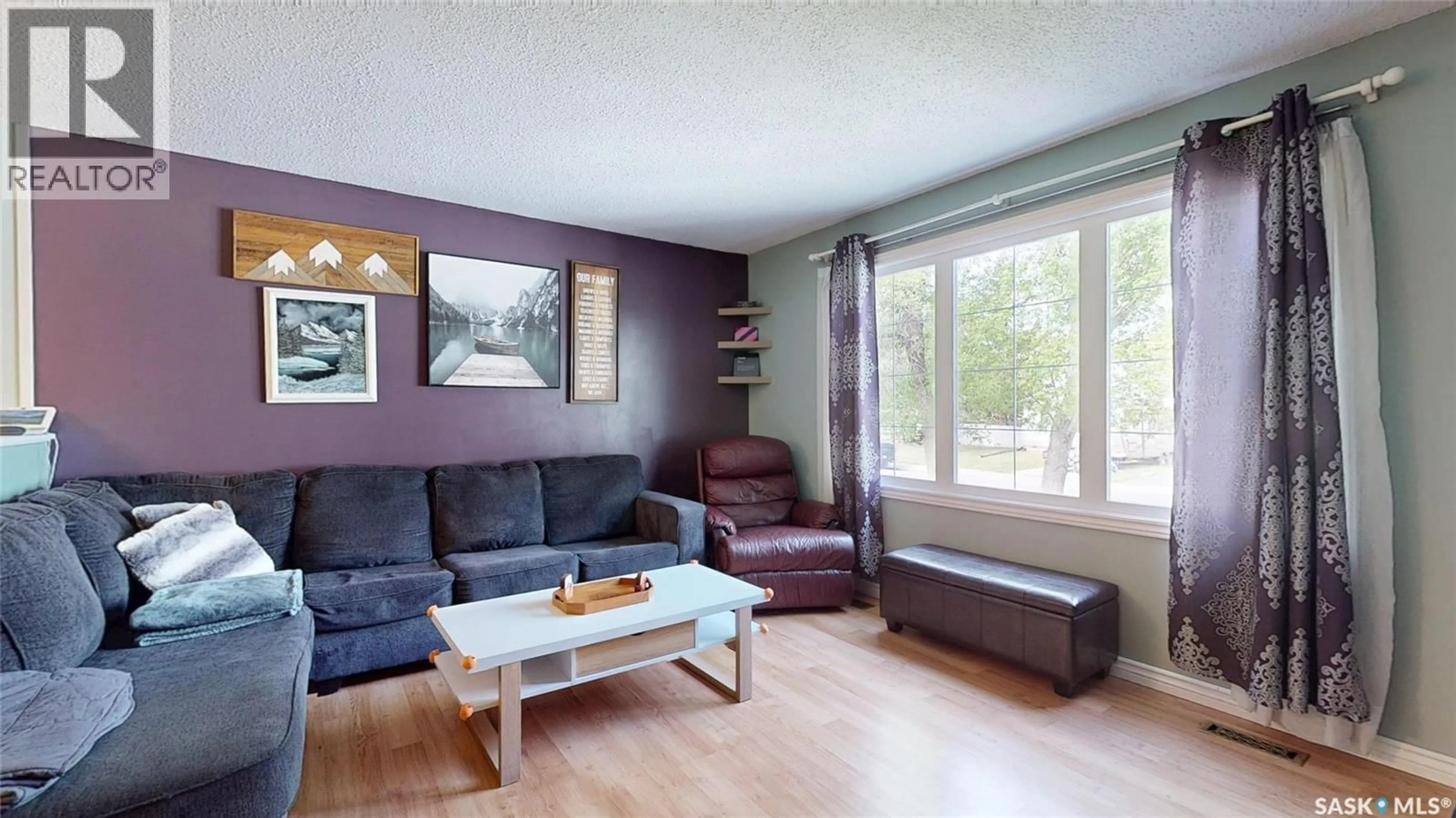 Living room with furniture, wood/laminate floor for 409 CORNWALL STREET, Regina Saskatchewan S4R2G9