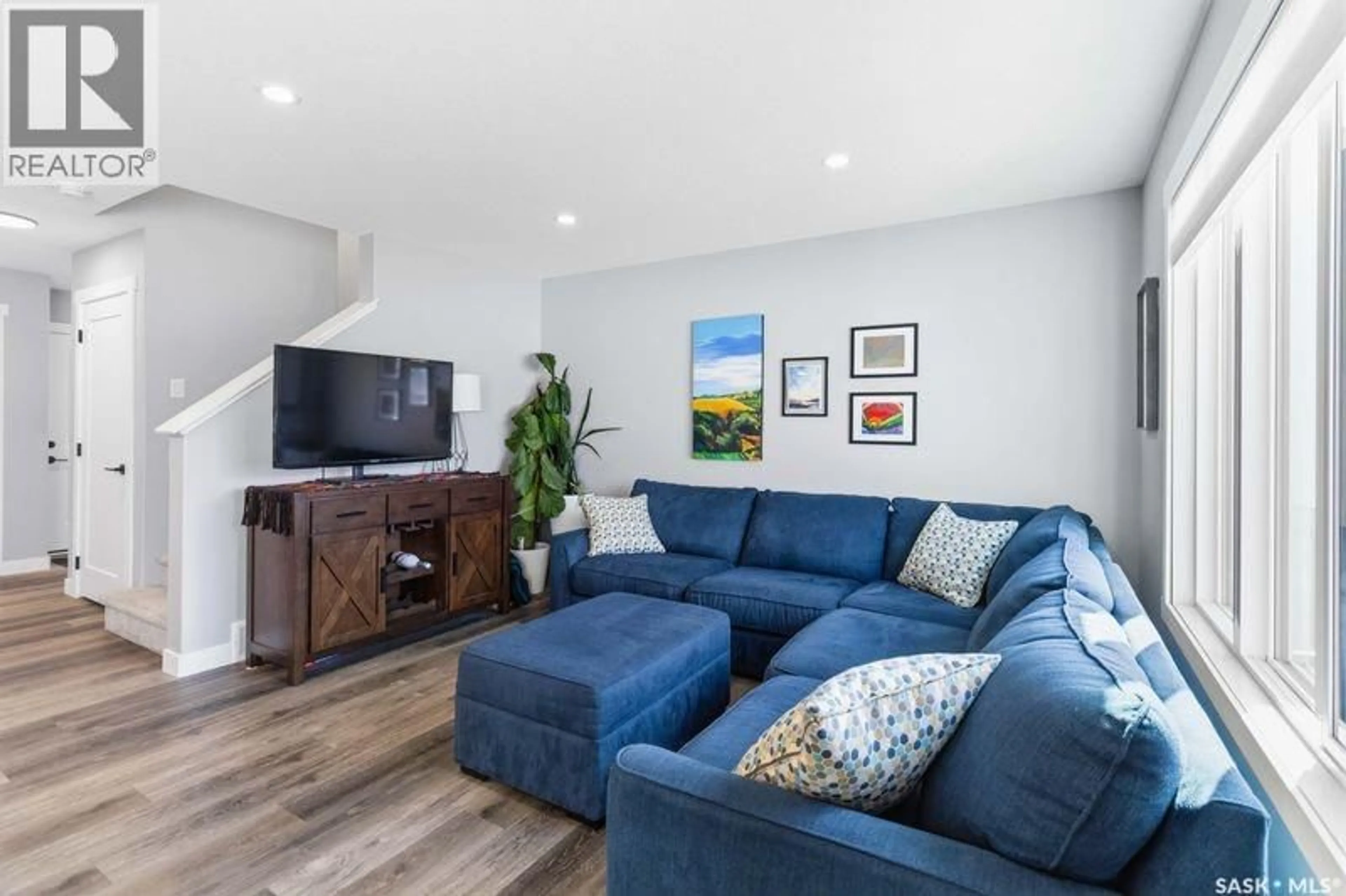 Living room with furniture, wood/laminate floor for 212 MYLES HEIDT LANE, Saskatoon Saskatchewan S7W1J1