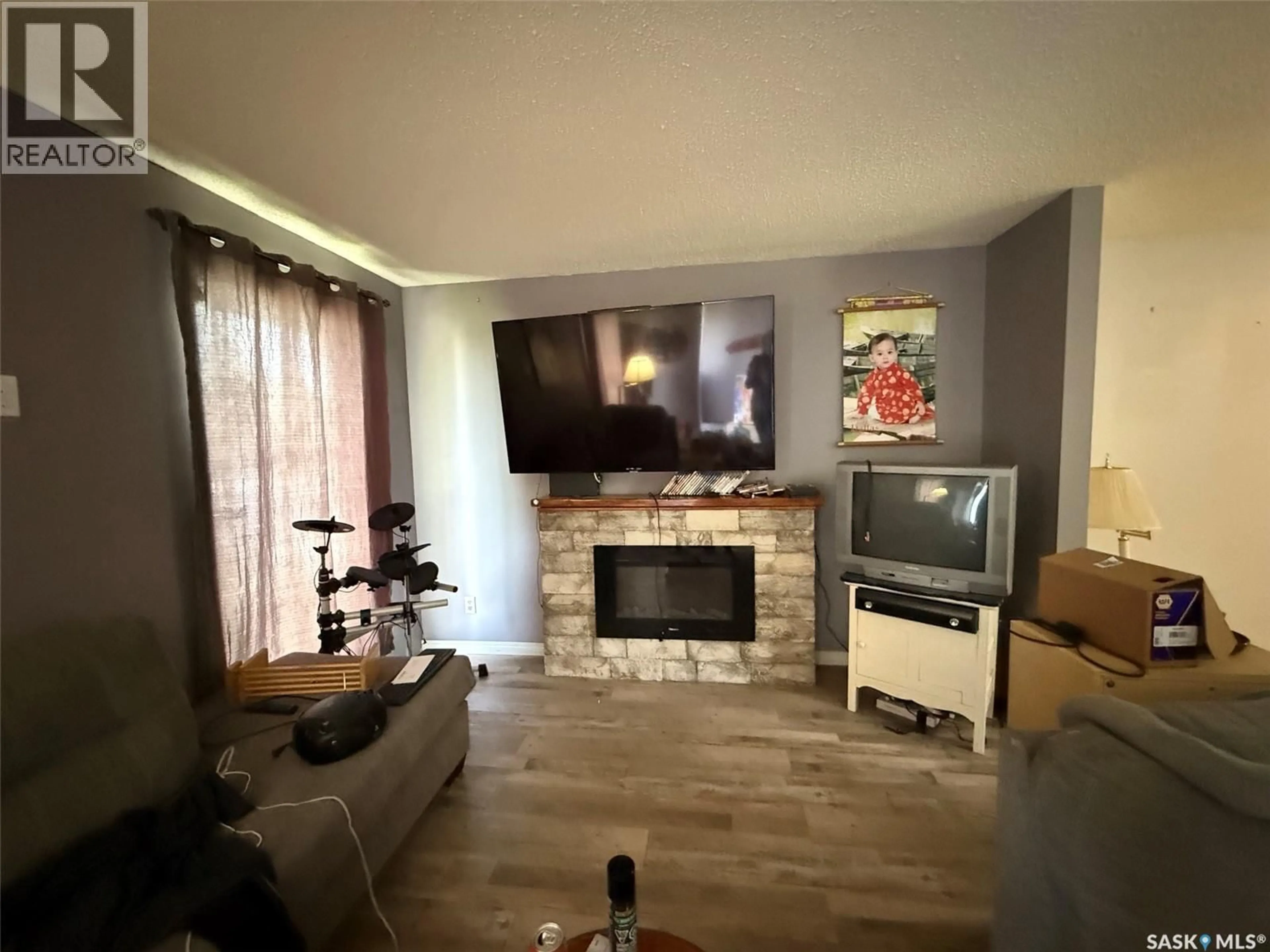 Living room with furniture, wood/laminate floor for 8912 DEANS CRESCENT, North Battleford Saskatchewan S9A3H7