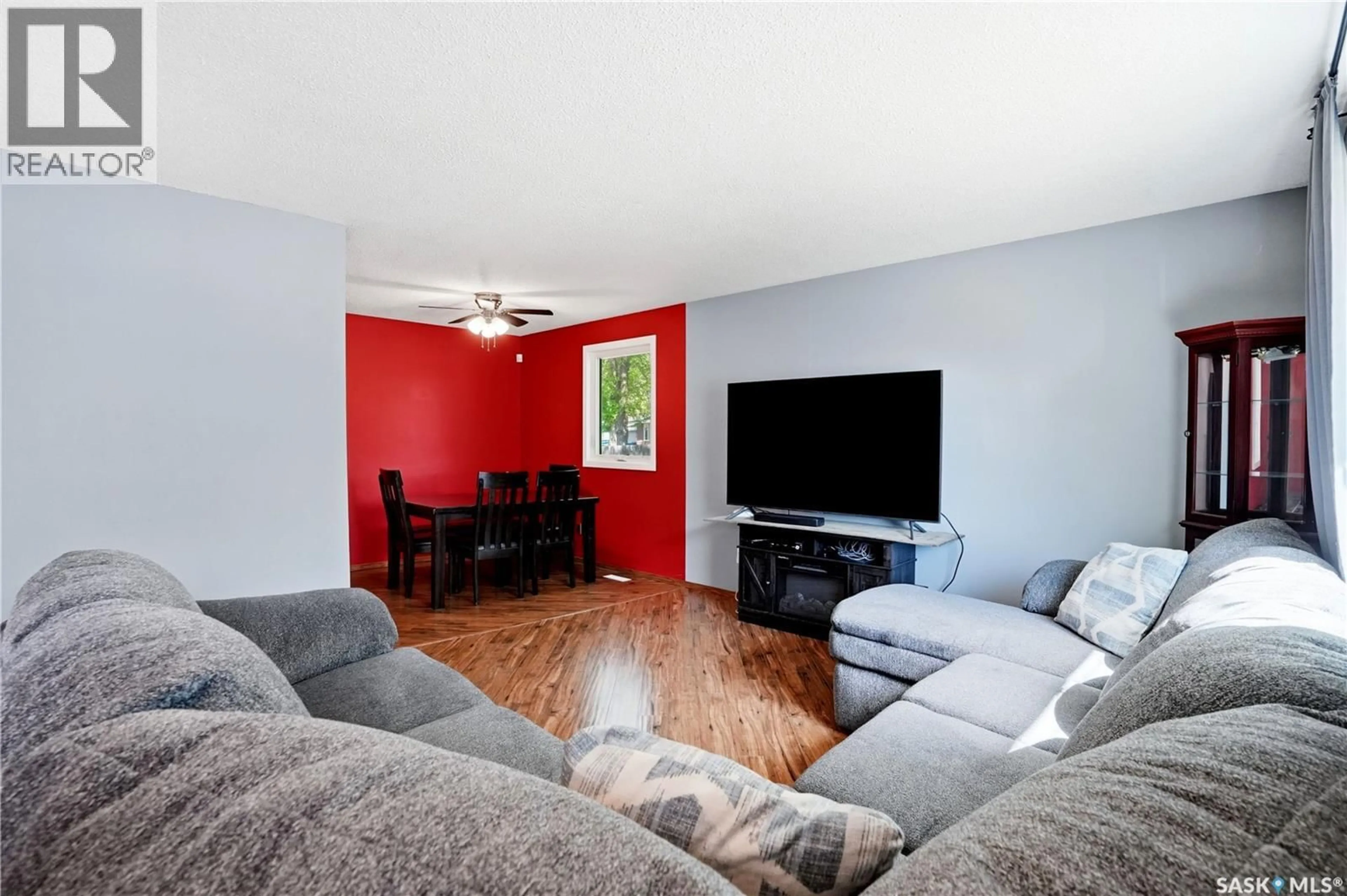 Living room with furniture, wood/laminate floor for 66 NELLES STREET, Regina Saskatchewan S4X1M4