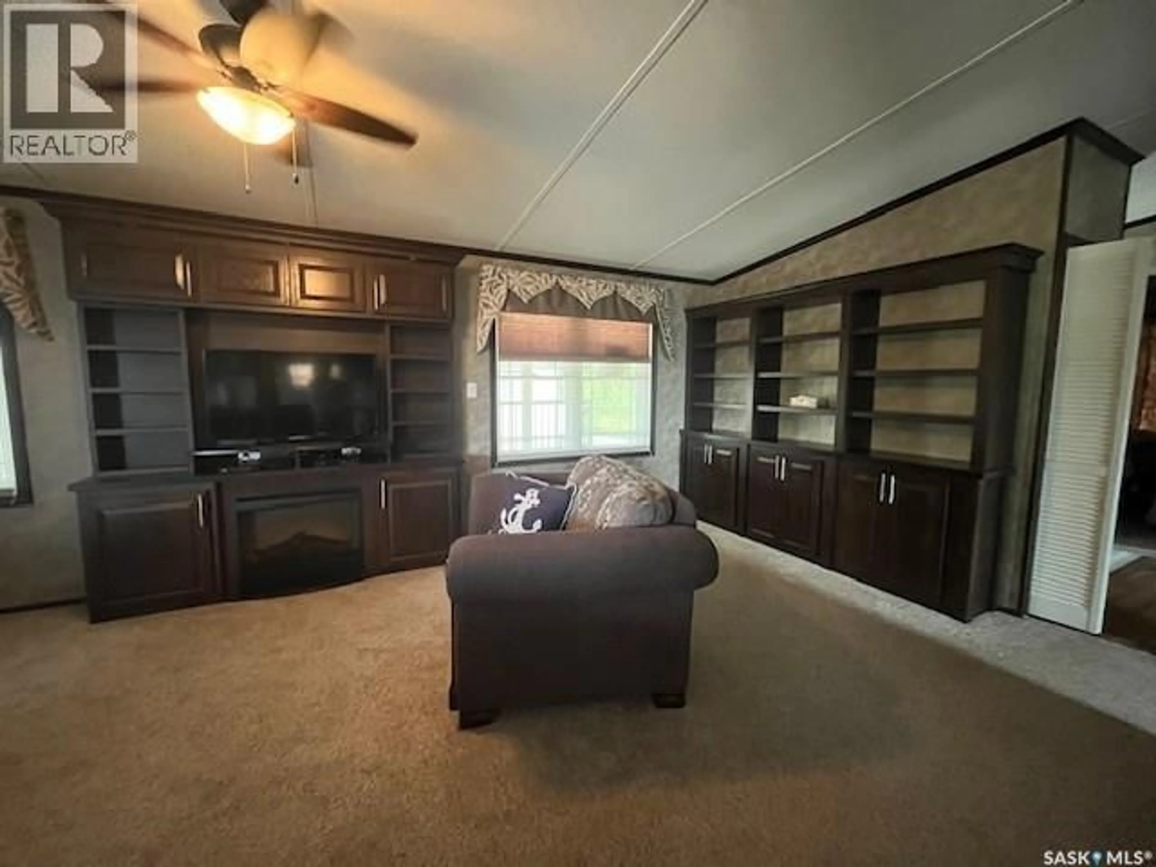 Living room with furniture, wood/laminate floor for 1207 OAK AVENUE, Beaver River Rm No. 622 Saskatchewan S0M1A0