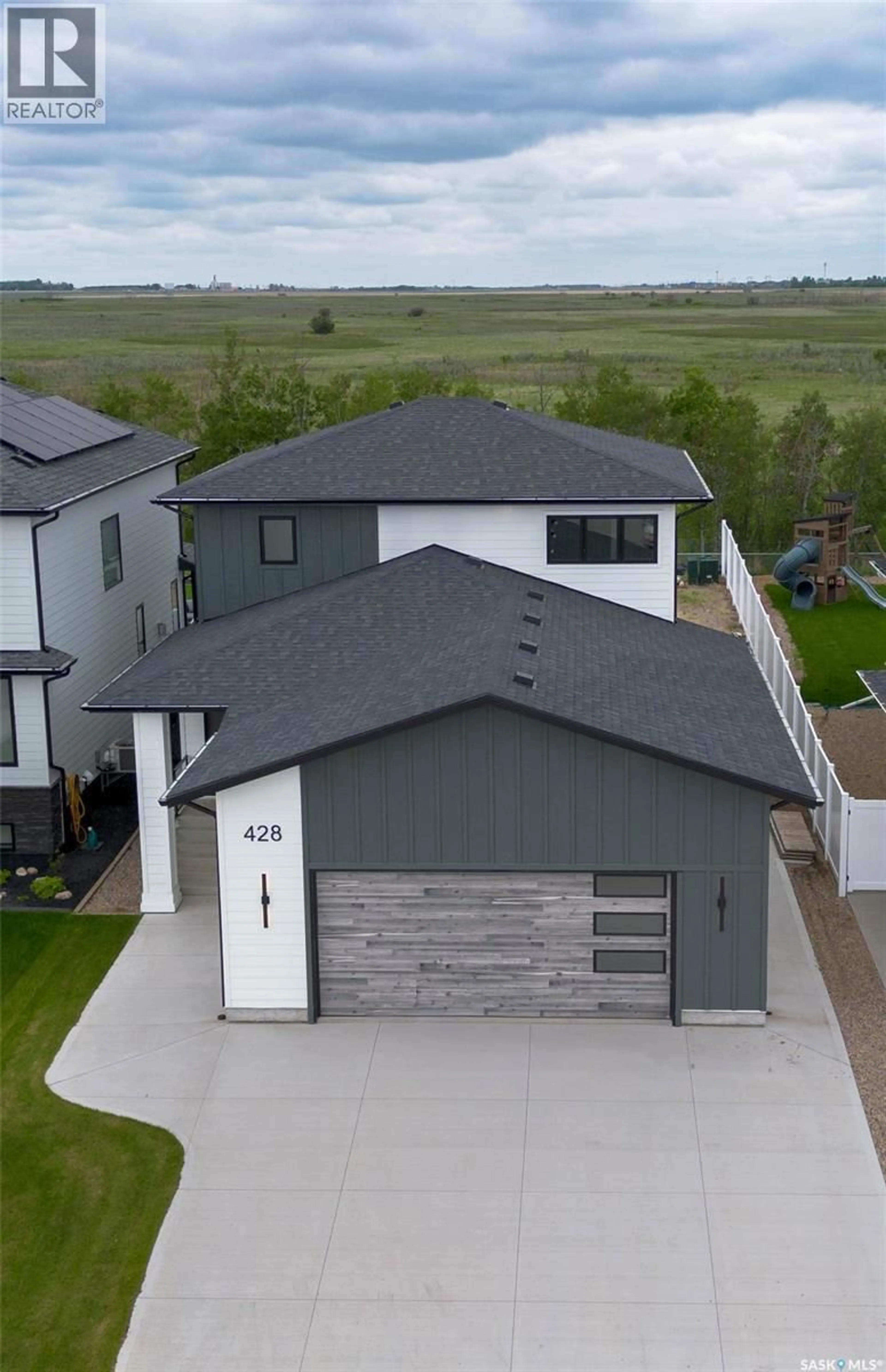A pic from outside/outdoor area/front of a property/back of a property/a pic from drone, unknown for 428 WOOLF BEND, Saskatoon Saskatchewan S7W1E5