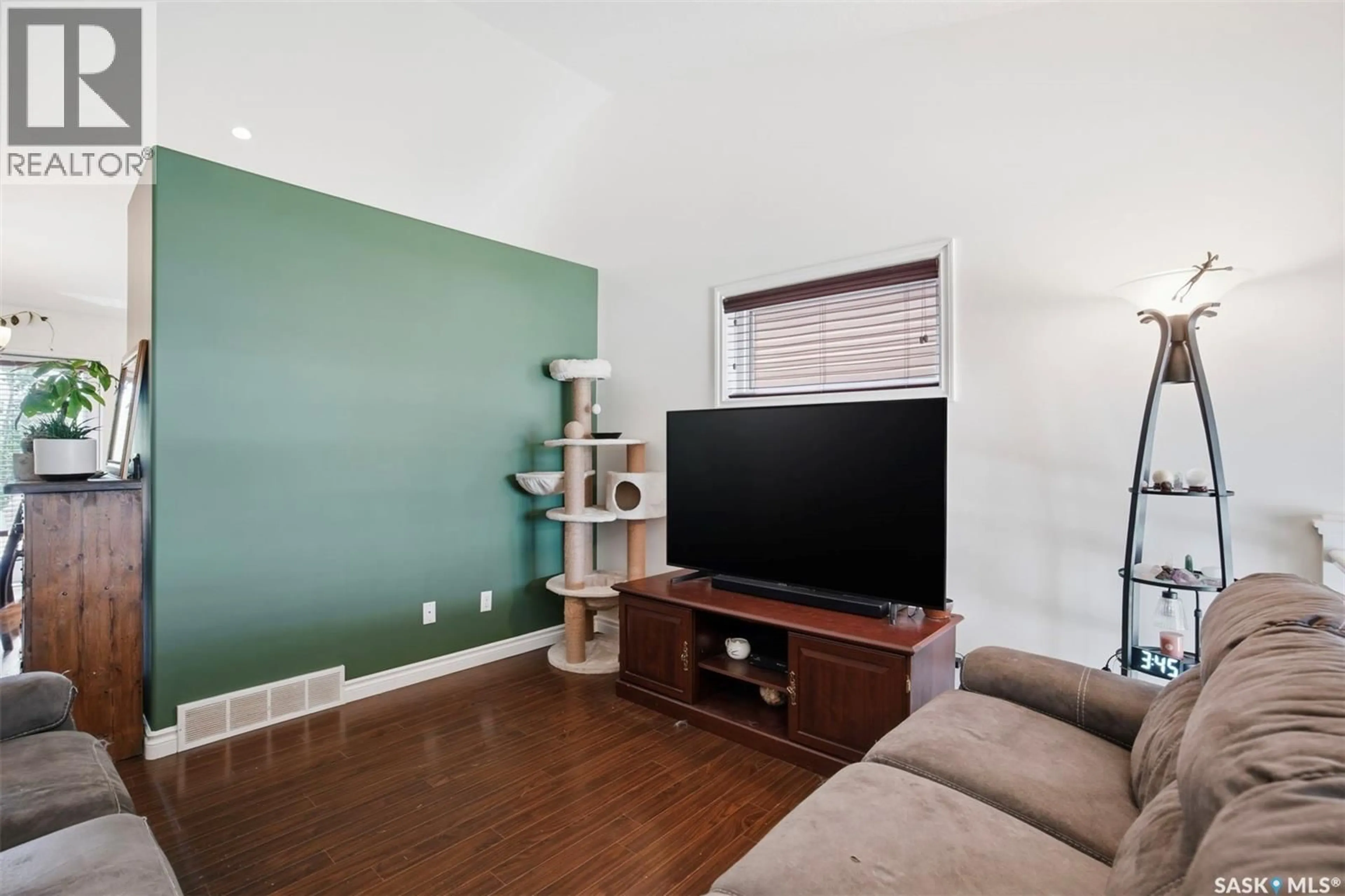 Living room with furniture, wood/laminate floor for 222 PARKVIEW COVE, Osler Saskatchewan S0K3A0