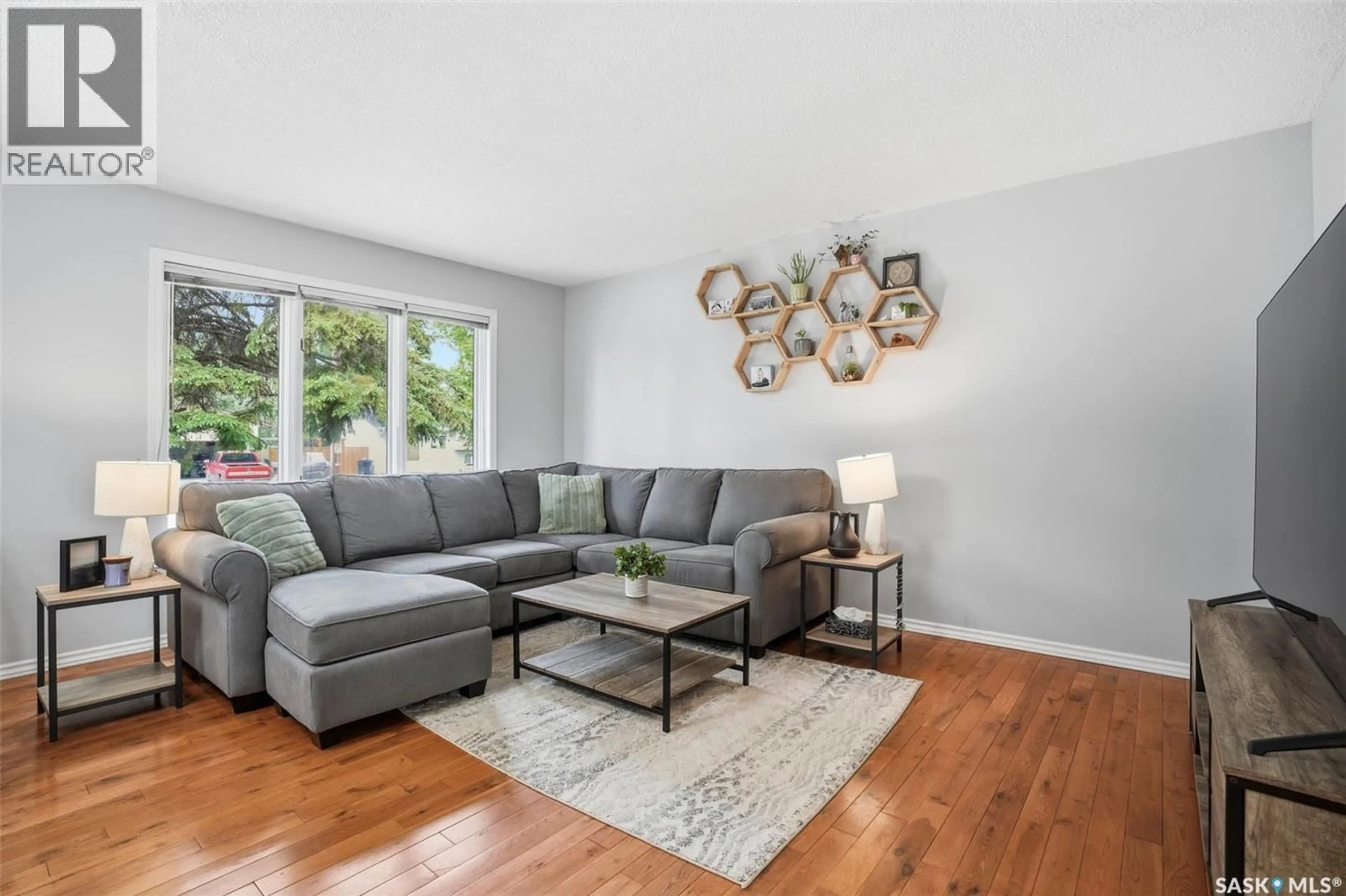 Living room with furniture, wood/laminate floor for 143 ADILMAN DRIVE, Saskatoon Saskatchewan S7K7P3
