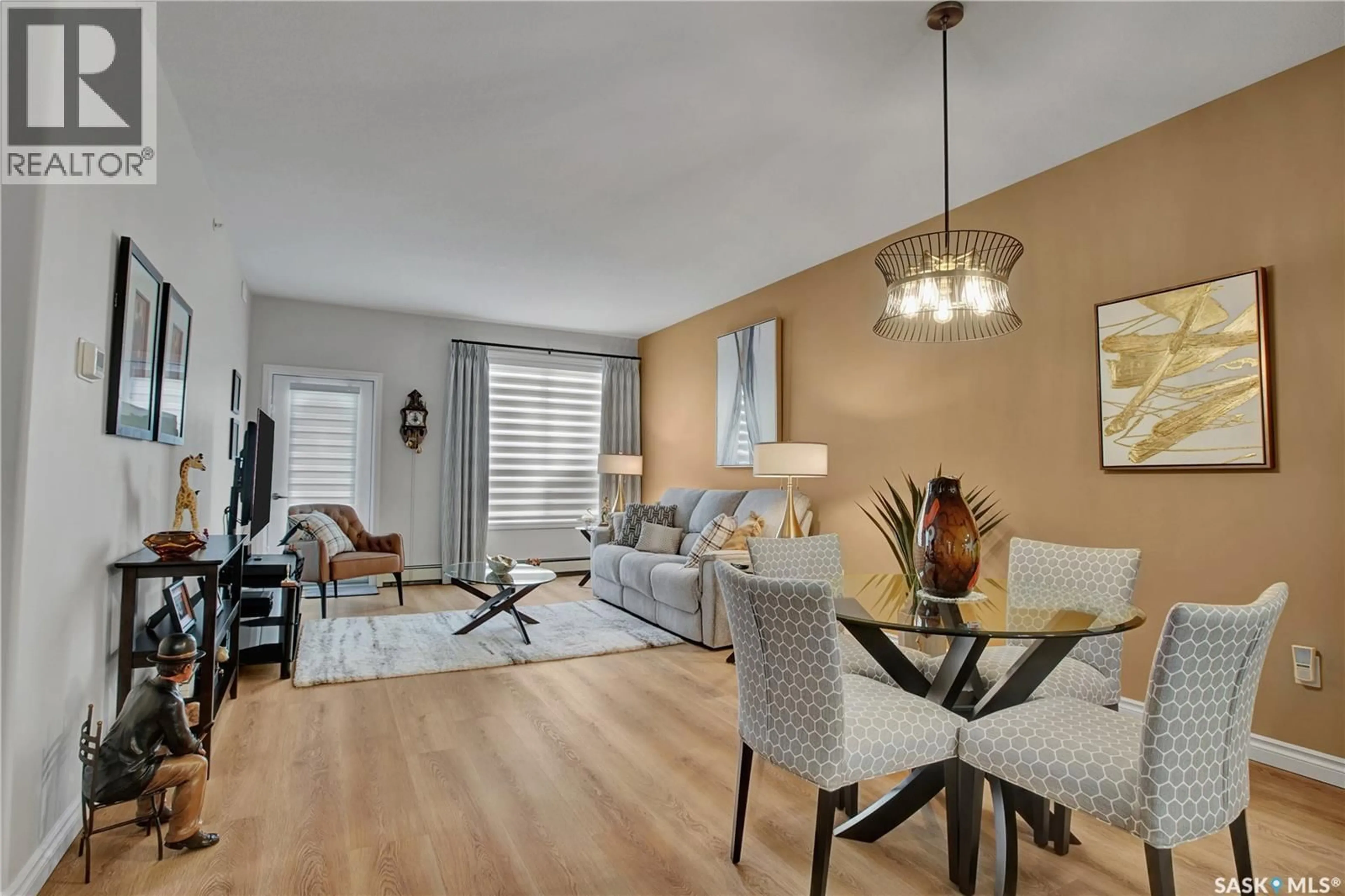 Living room with furniture, wood/laminate floor for 309 - 2730 MAIN STREET, Saskatoon Saskatchewan S7H0M3