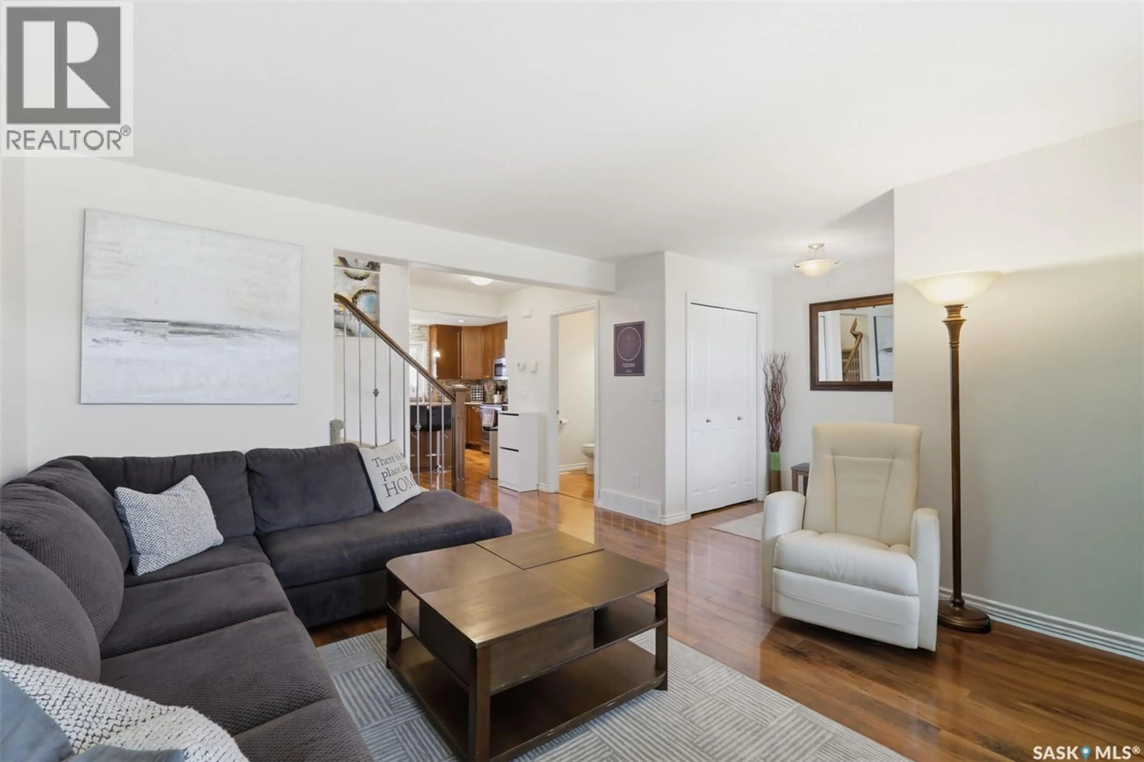Living room with furniture, wood/laminate floor for 646 HAMPTON CIRCLE, Saskatoon Saskatchewan S7R0J5