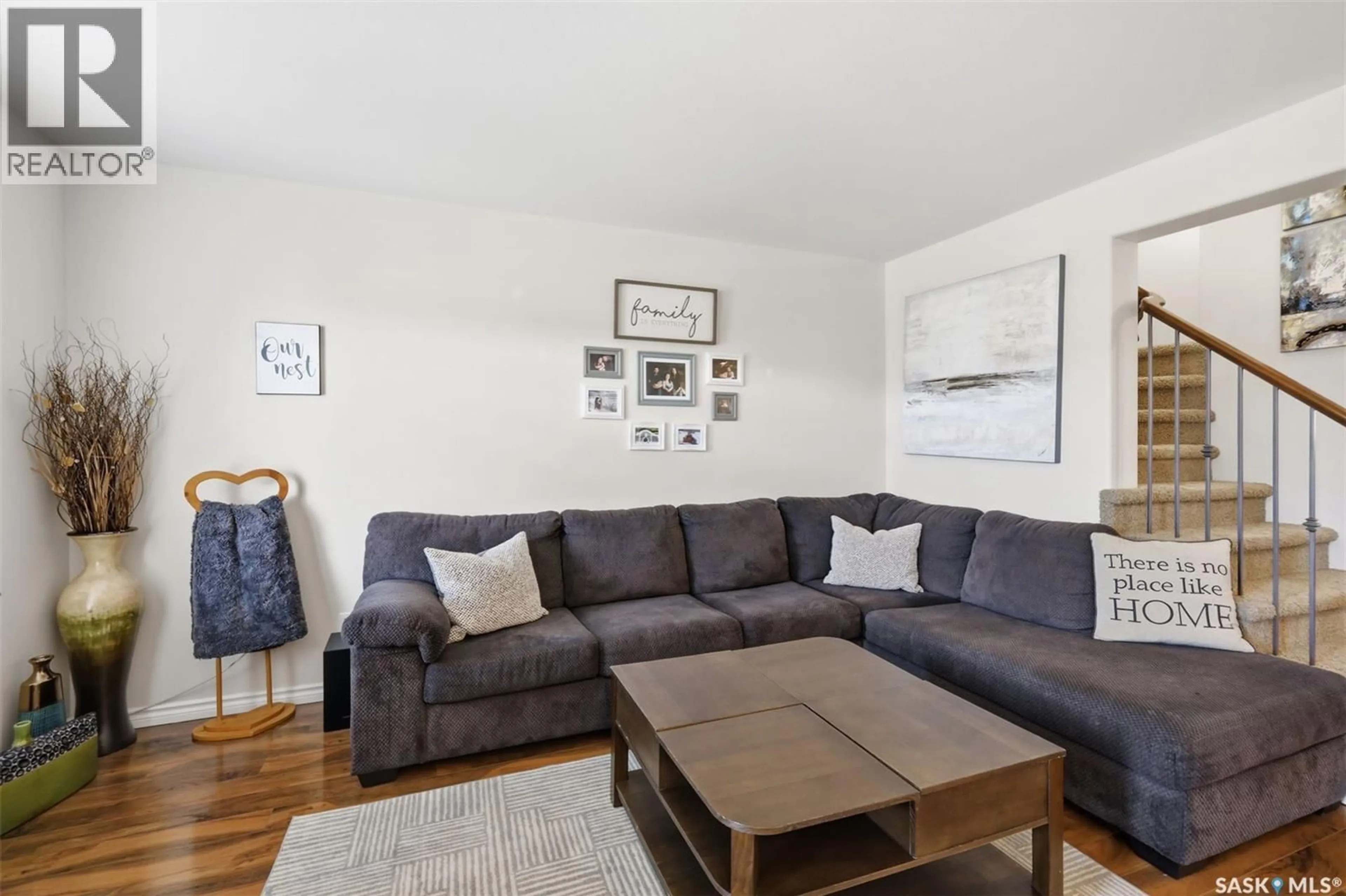 Living room with furniture, wood/laminate floor for 646 HAMPTON CIRCLE, Saskatoon Saskatchewan S7R0J5