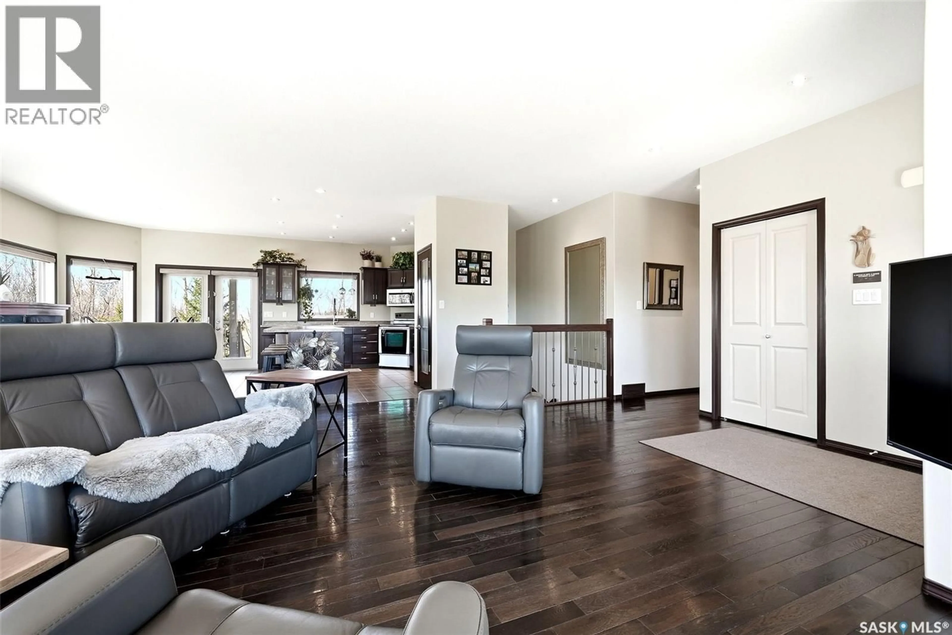 Living room with furniture, wood/laminate floor for 24 BARDEL CRESCENT, Pilot Butte Saskatchewan S0G3Z0