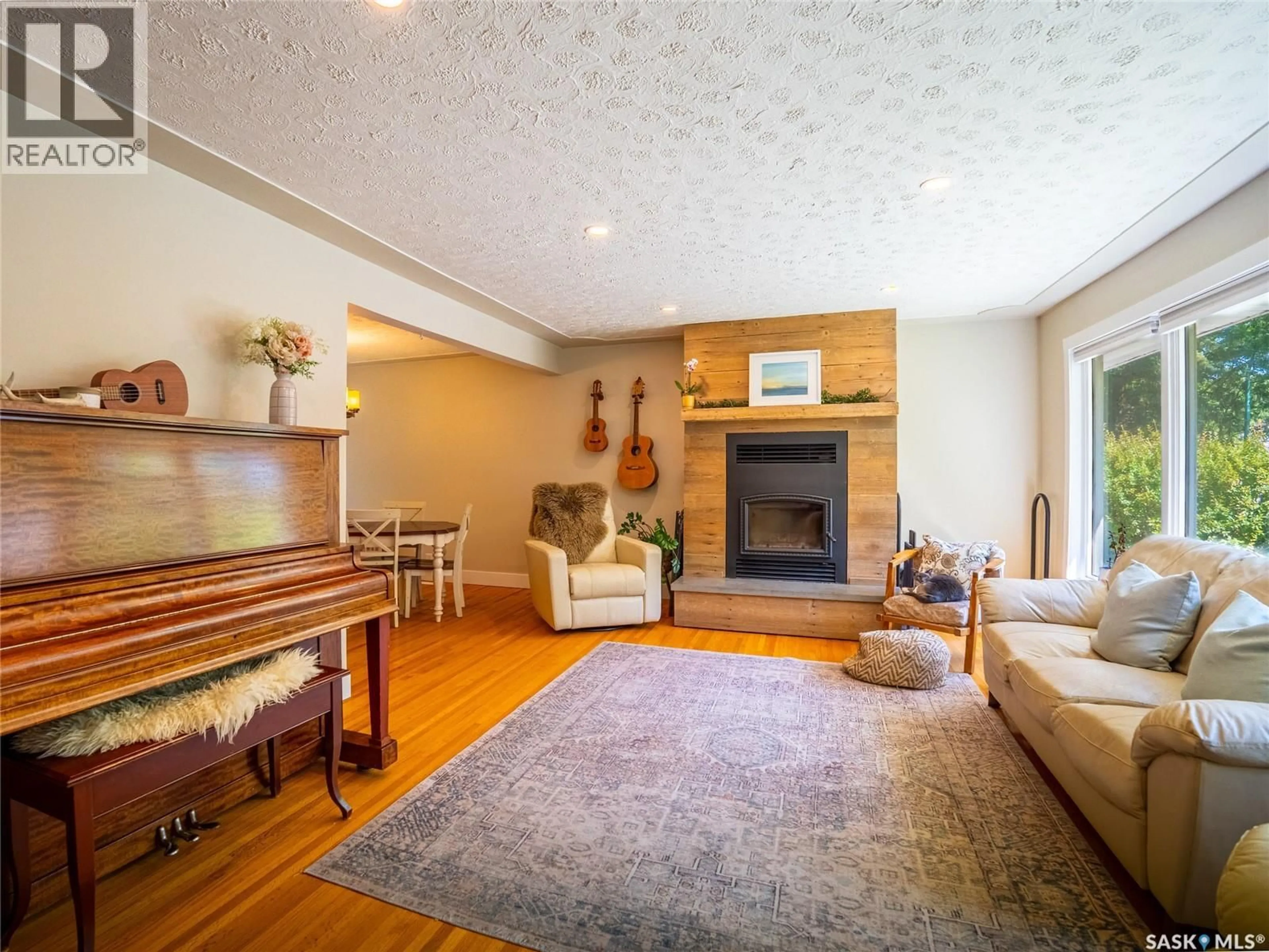 Living room with furniture, wood/laminate floor for 22 CALDER CRESCENT, Regina Saskatchewan S4S4A6