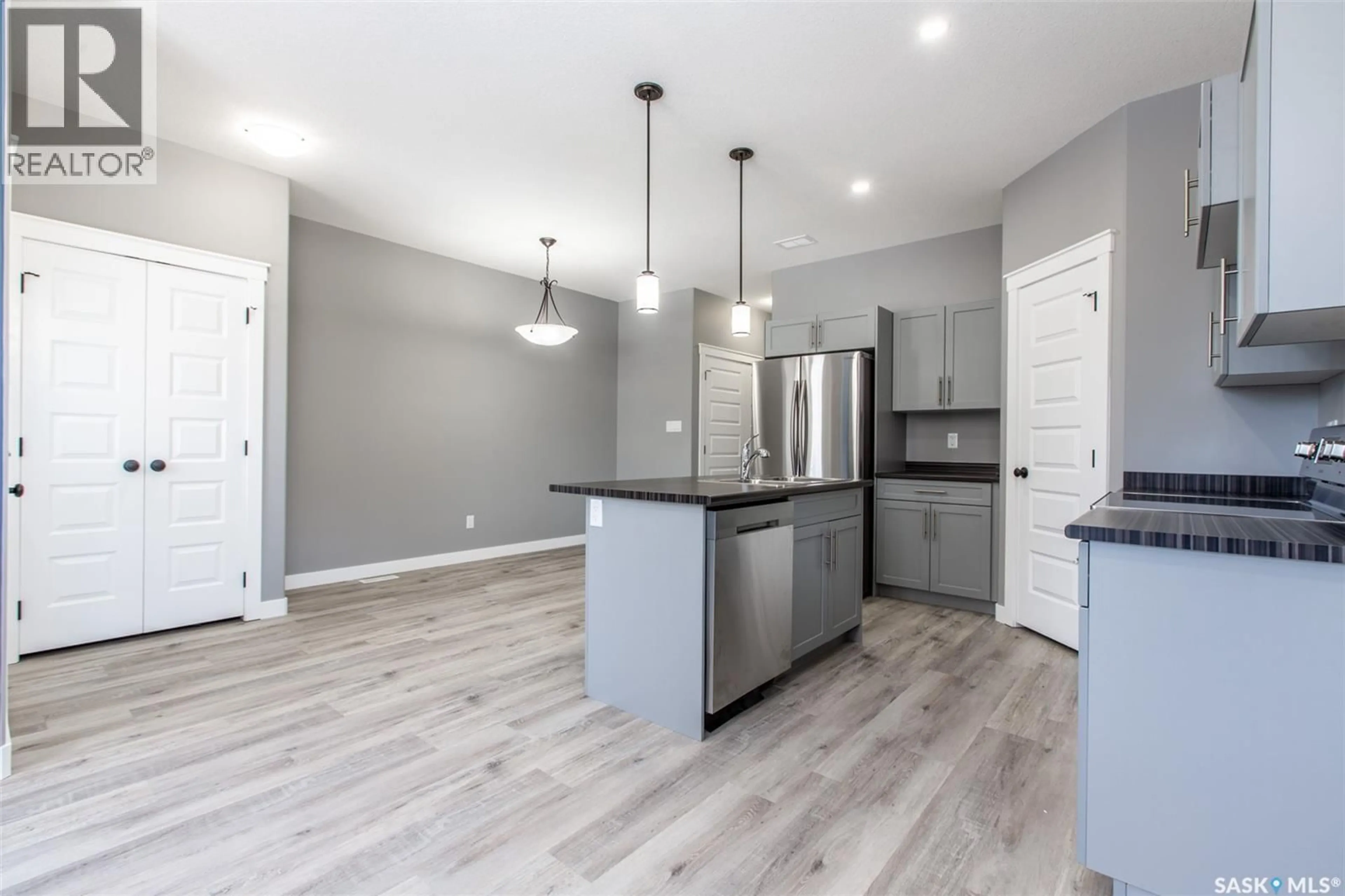 Open concept kitchen, wood/laminate floor for 2748 MACKAY STREET, Regina Saskatchewan S4N2T7