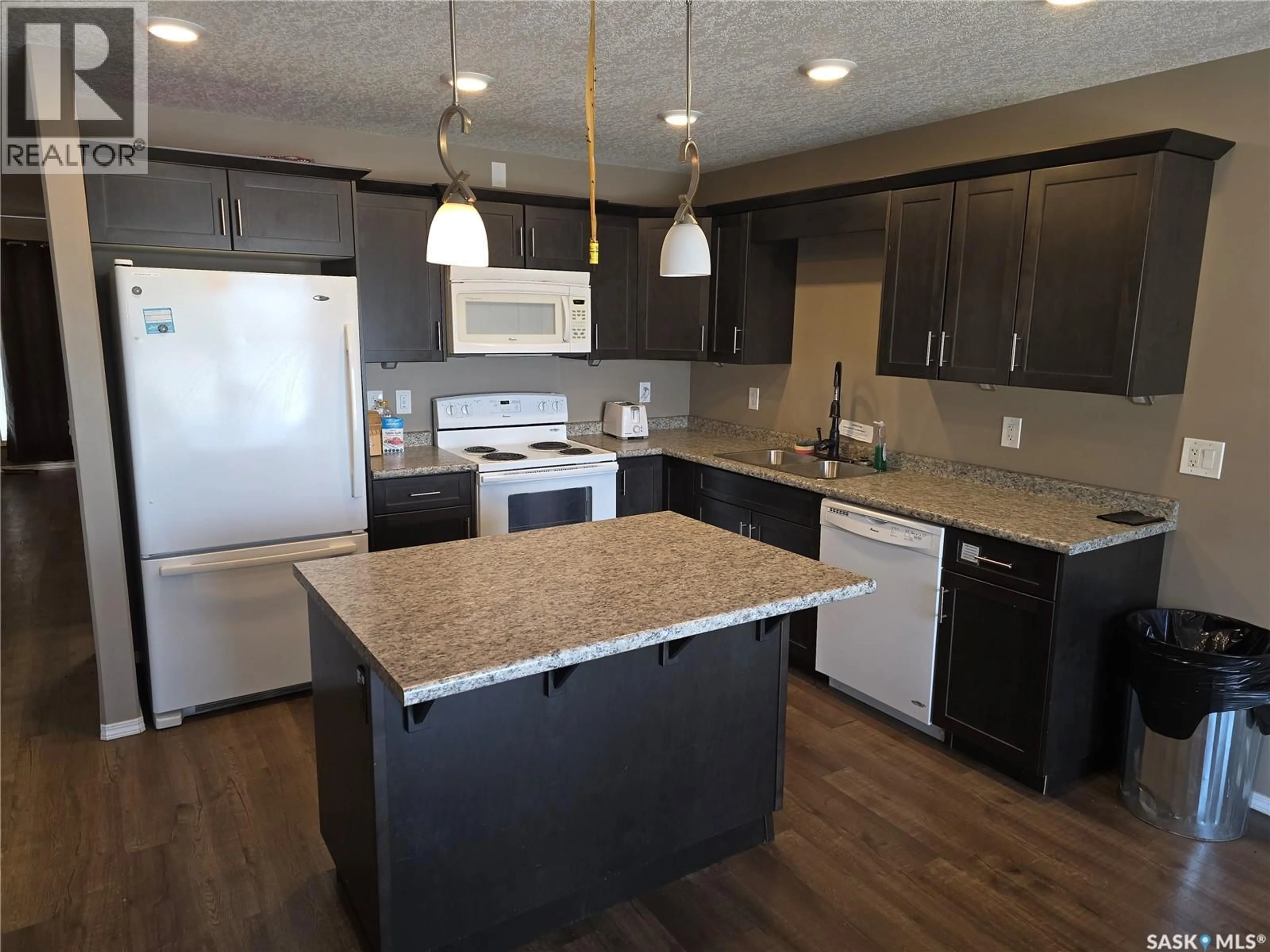 Open concept kitchen, wood/laminate floor for 714 COLUMBIA AVENUE, Kerrobert Saskatchewan S0L1R0